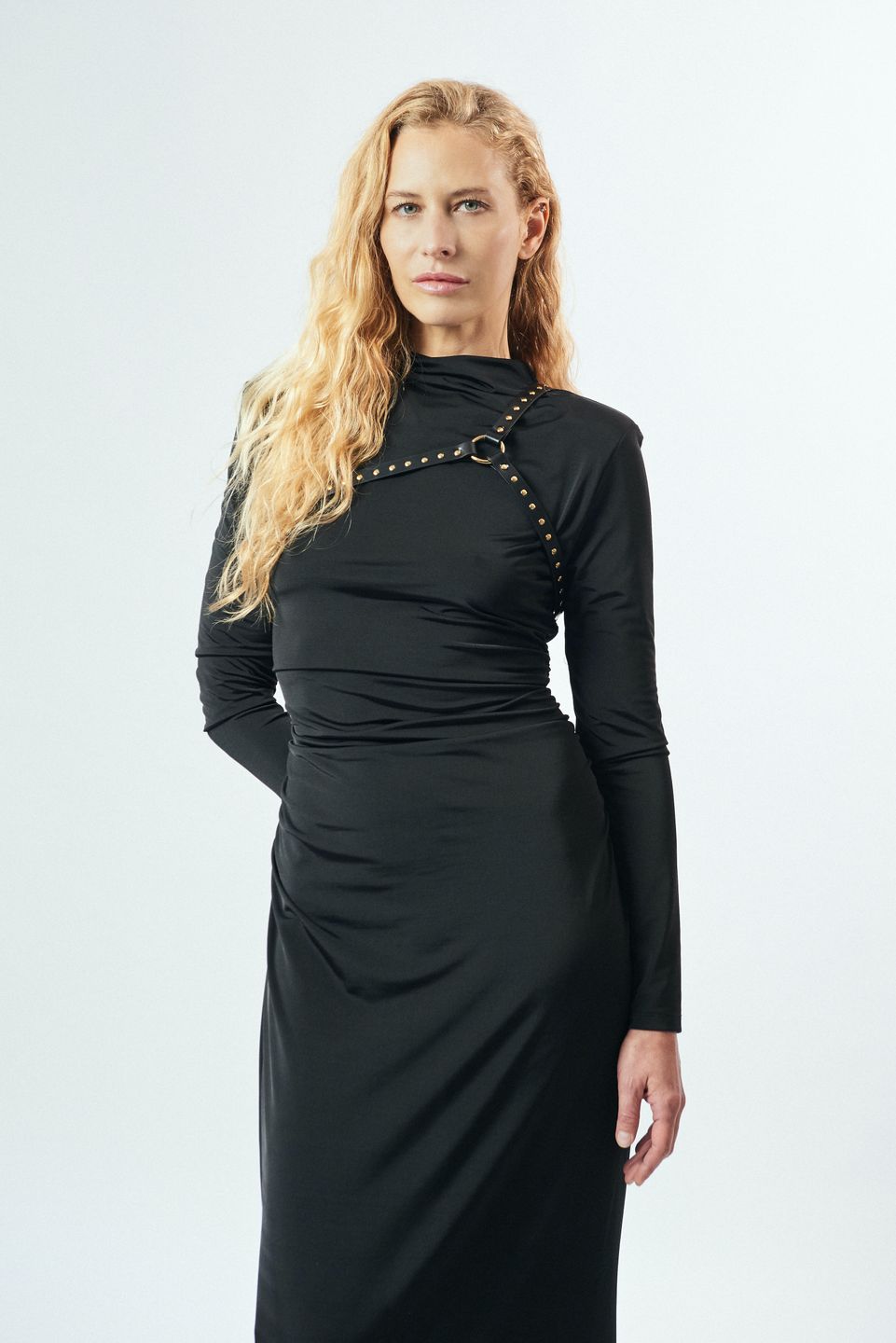 Model Sandra Jahn in a black dress wearing an YVY leather body harness. Natural makeup. Make-up by Denise Dedich in Zurich.