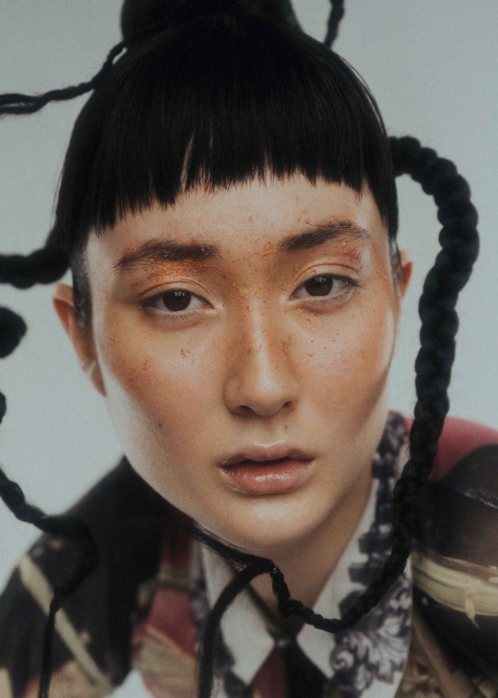 a woman with black hair and braids posing for a photo