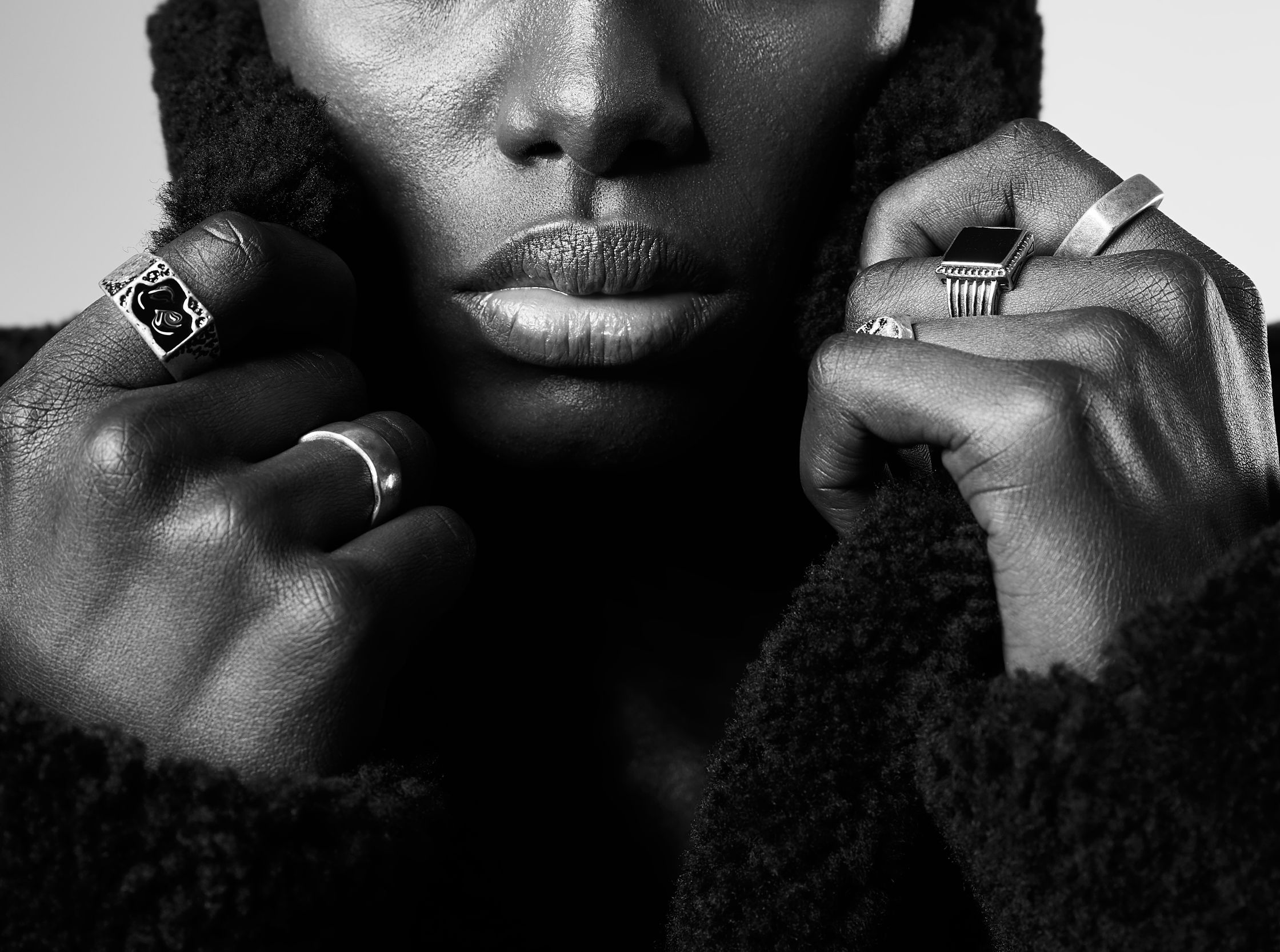 black and white photo of a woman wearing rings