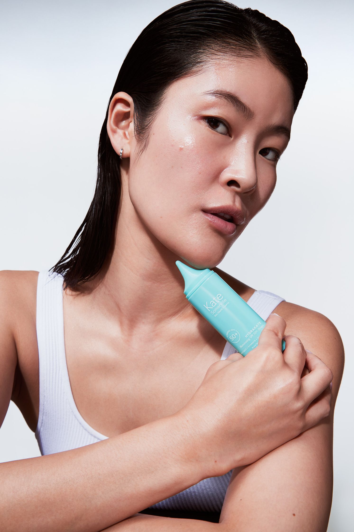 a woman is holding a blue toothbrush