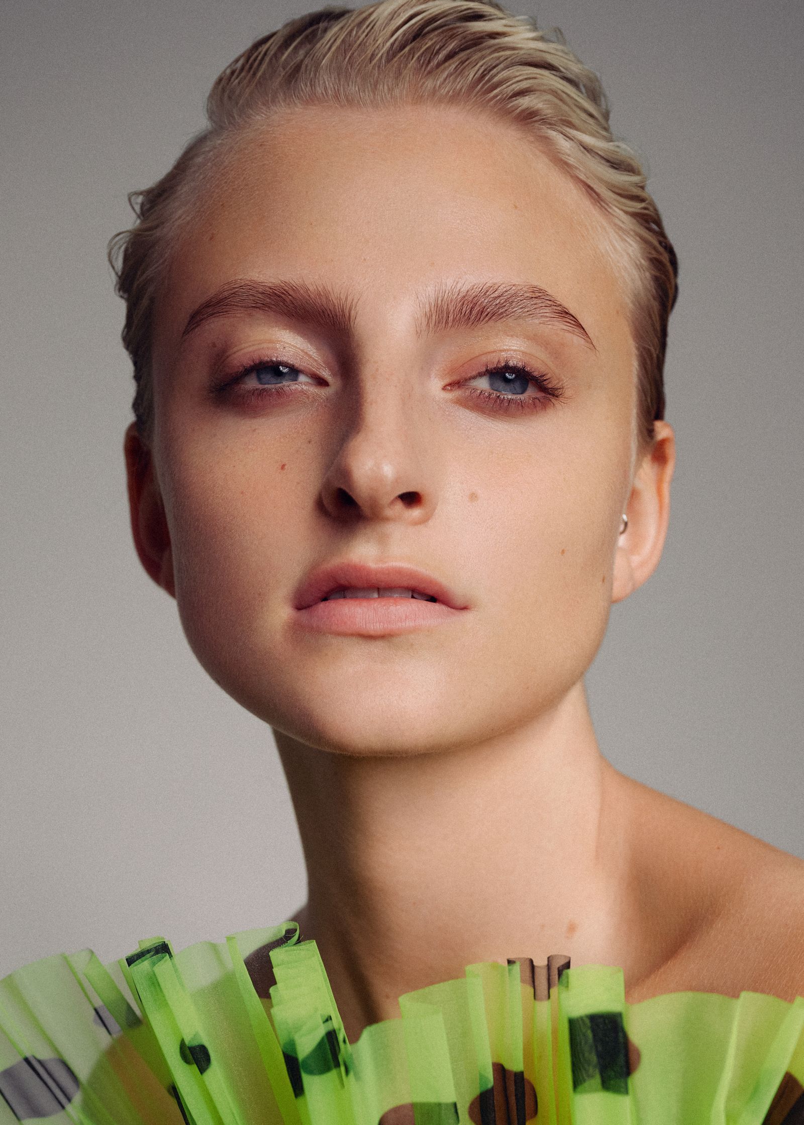 a woman in a green dress posing for a magazine