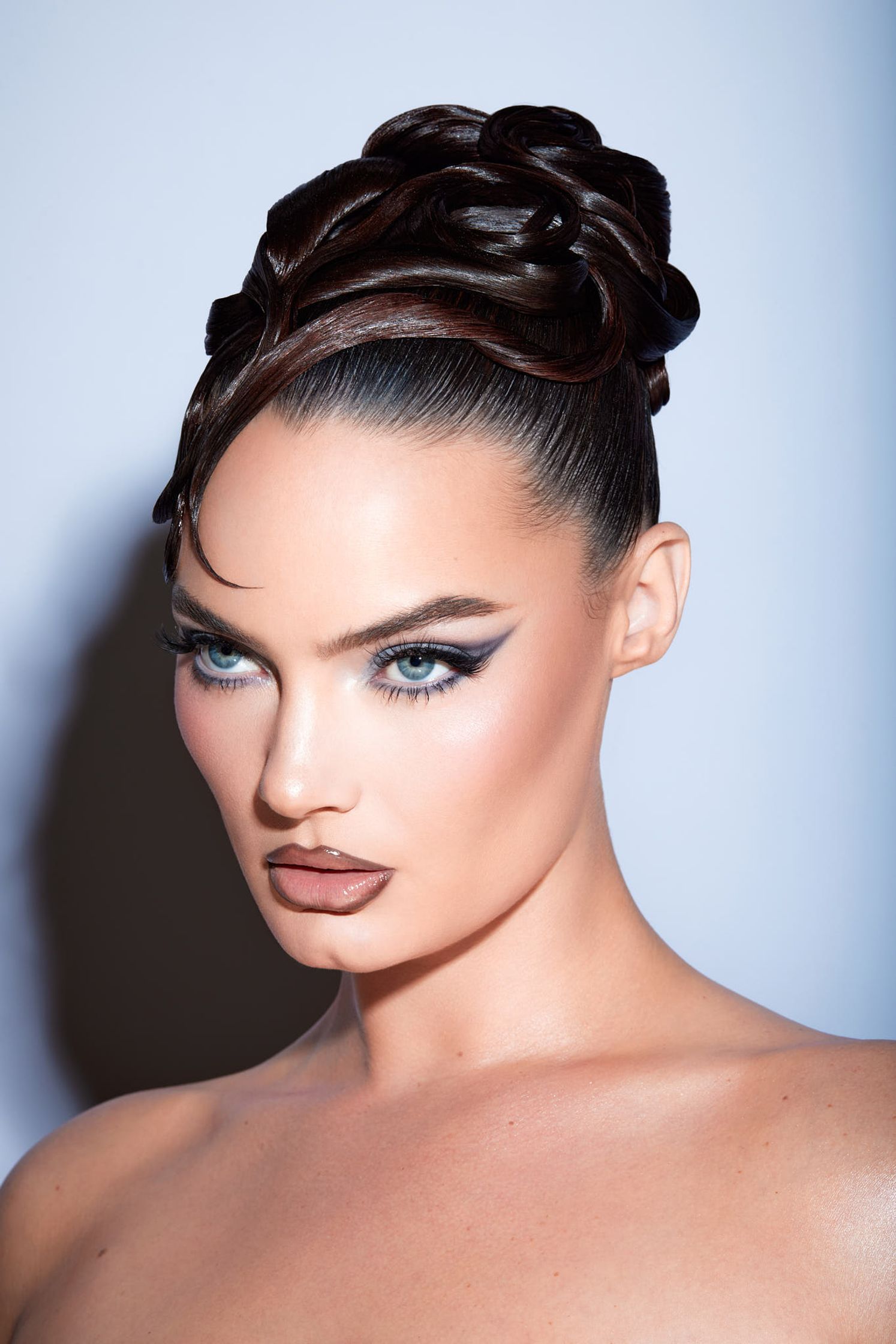 a woman with dark hair and makeup posing for a photo