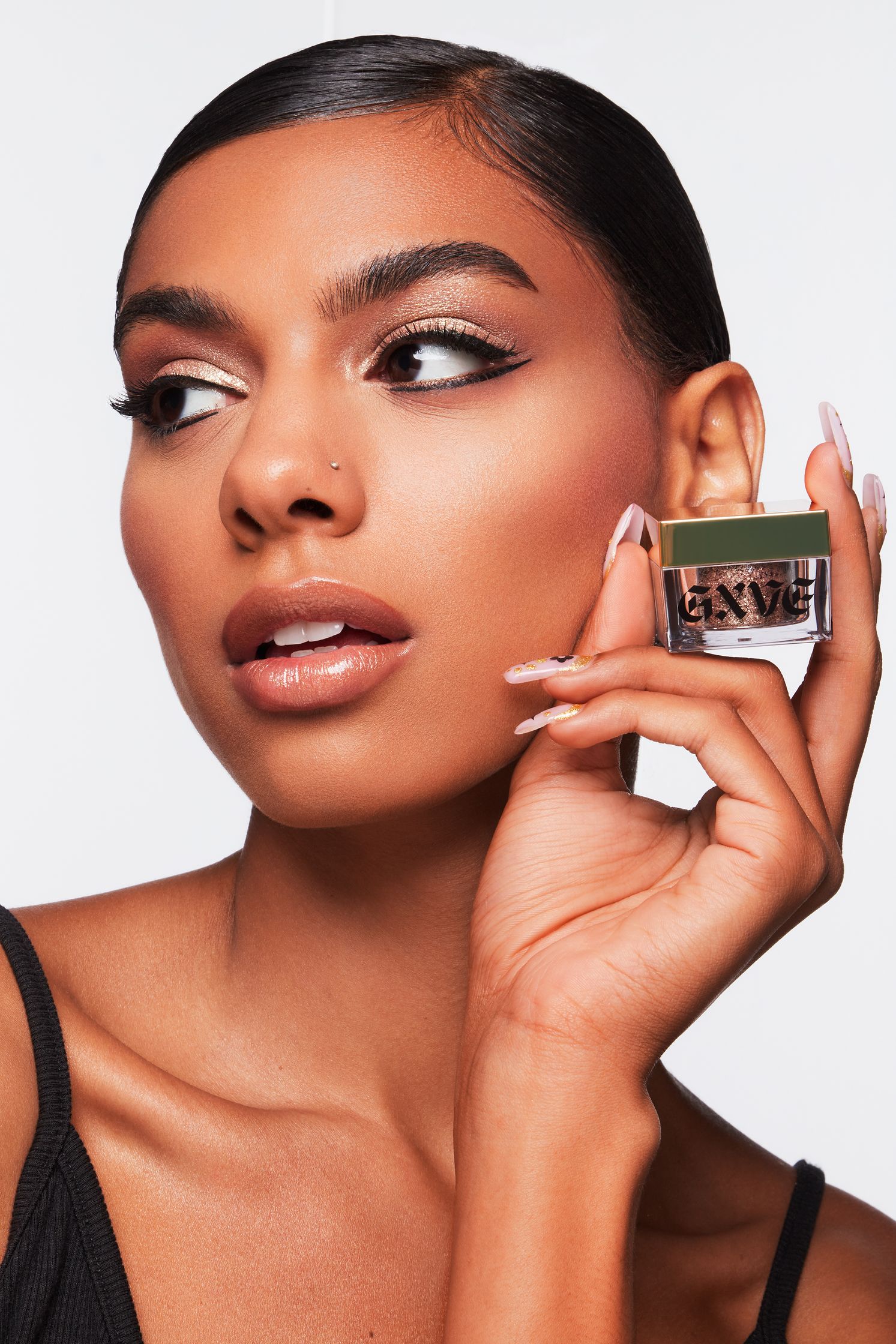 a woman is holding a jar of makeup in her hand