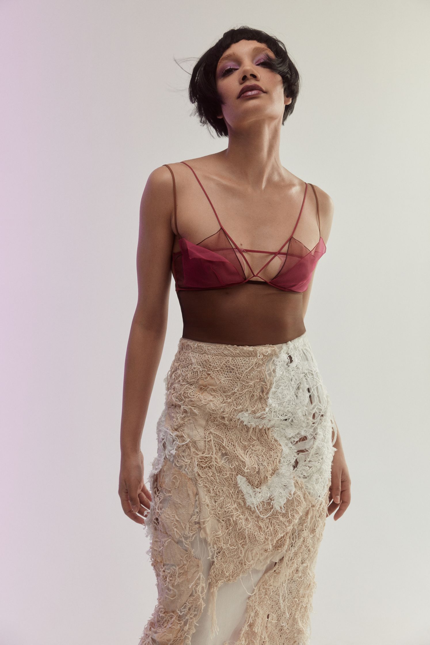a woman in a red top and a white skirt
