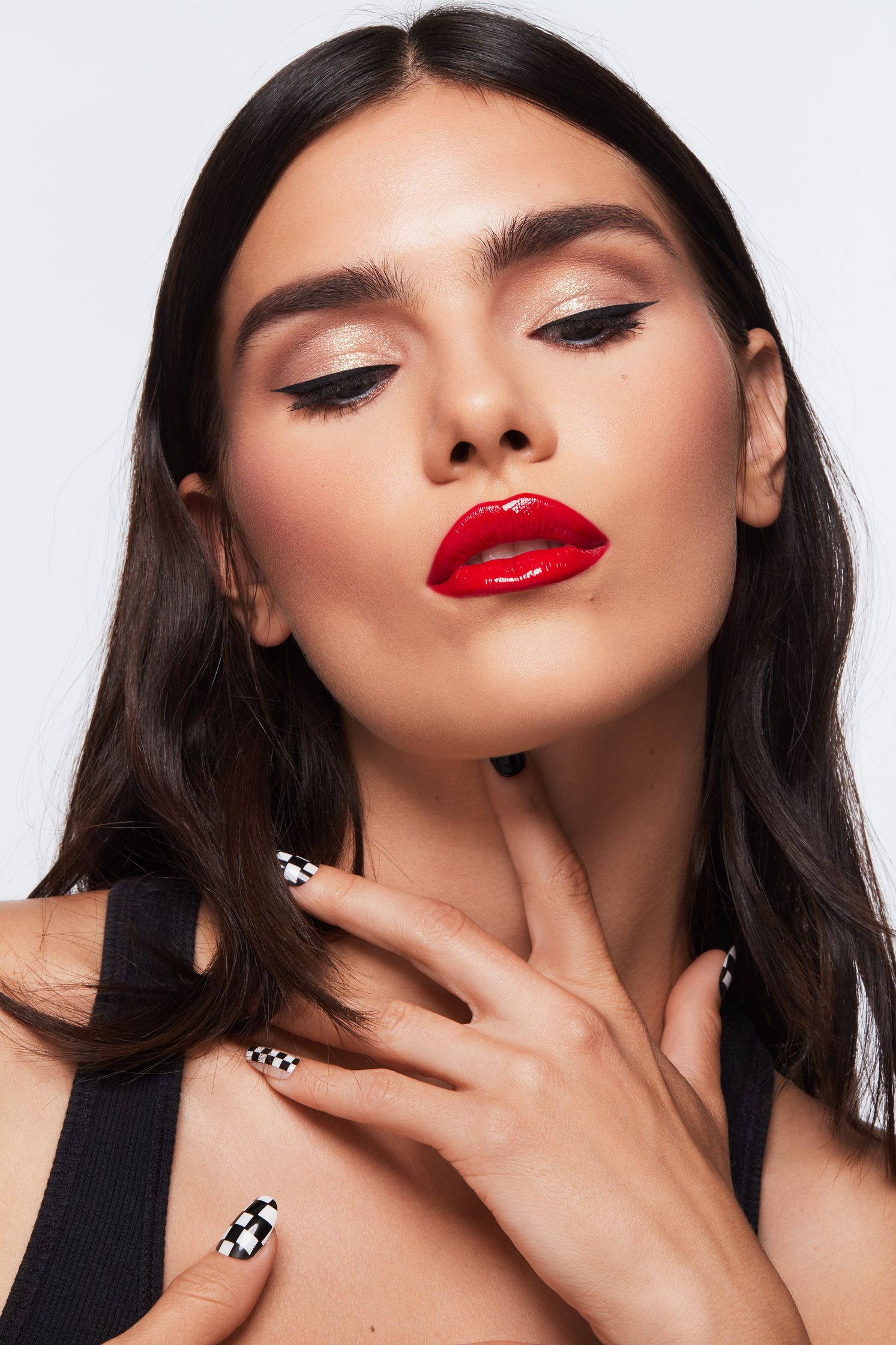 a woman wearing a black top and red lipstick