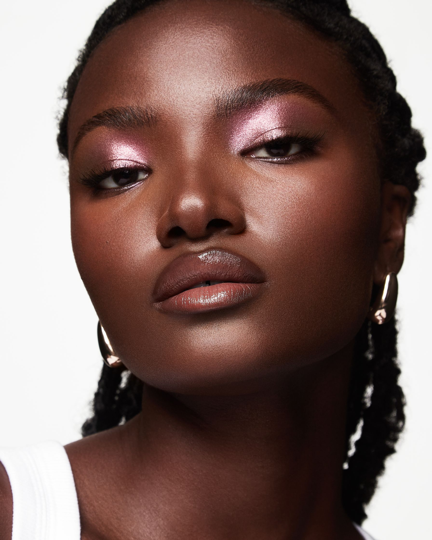 a black woman with pink eyeshadow and braided hair