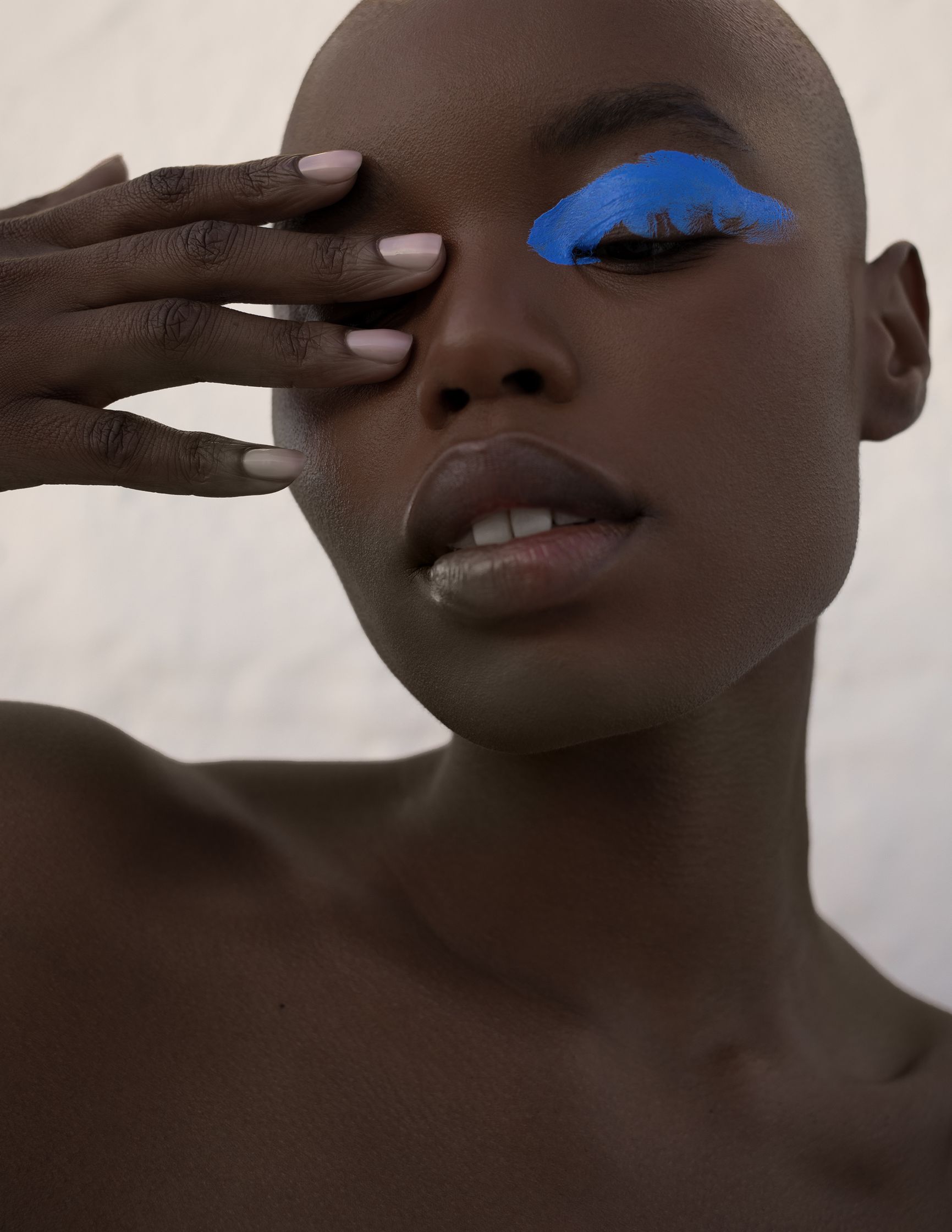 a black woman with blue eye makeup