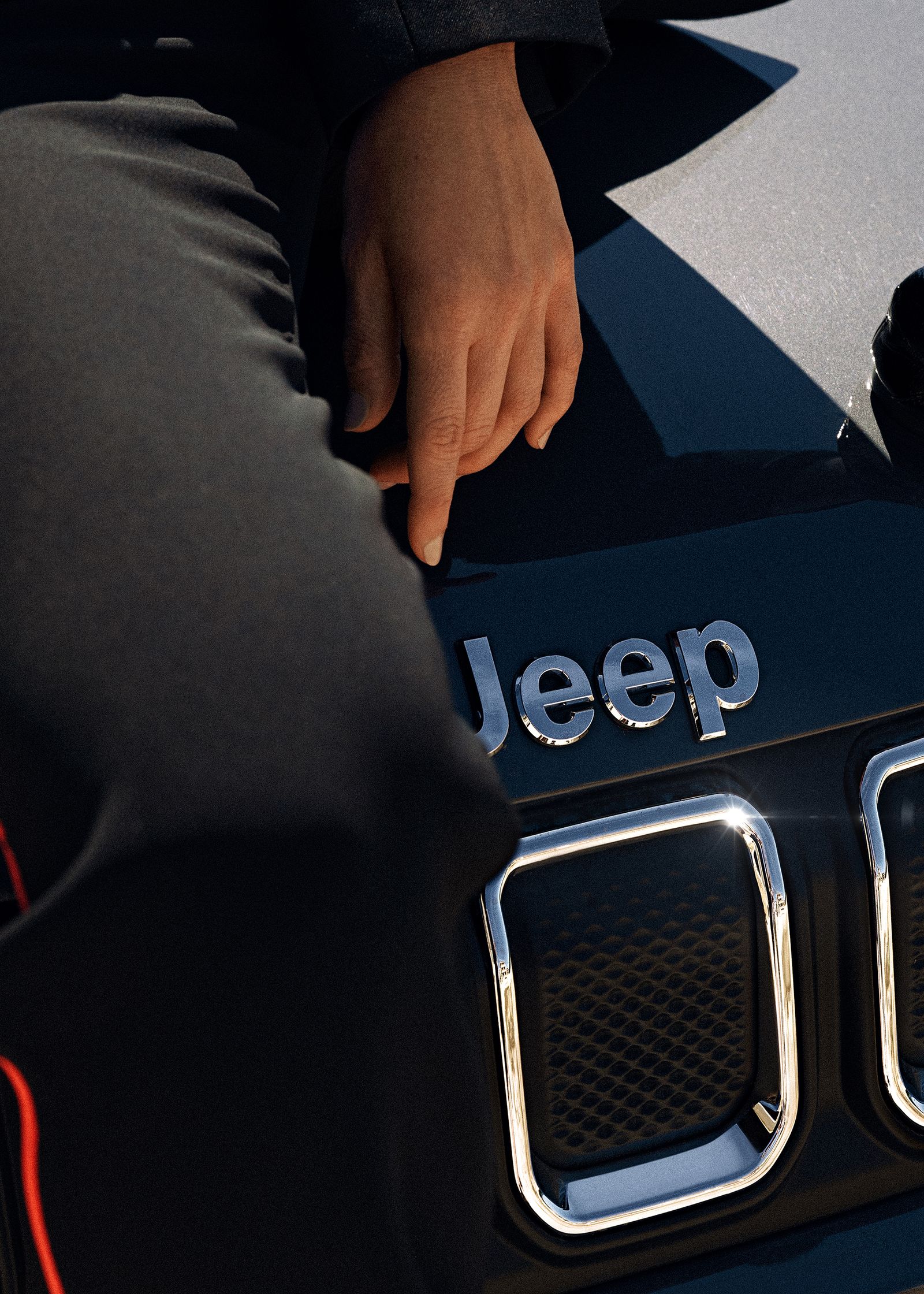 a person sitting on a jeep hood