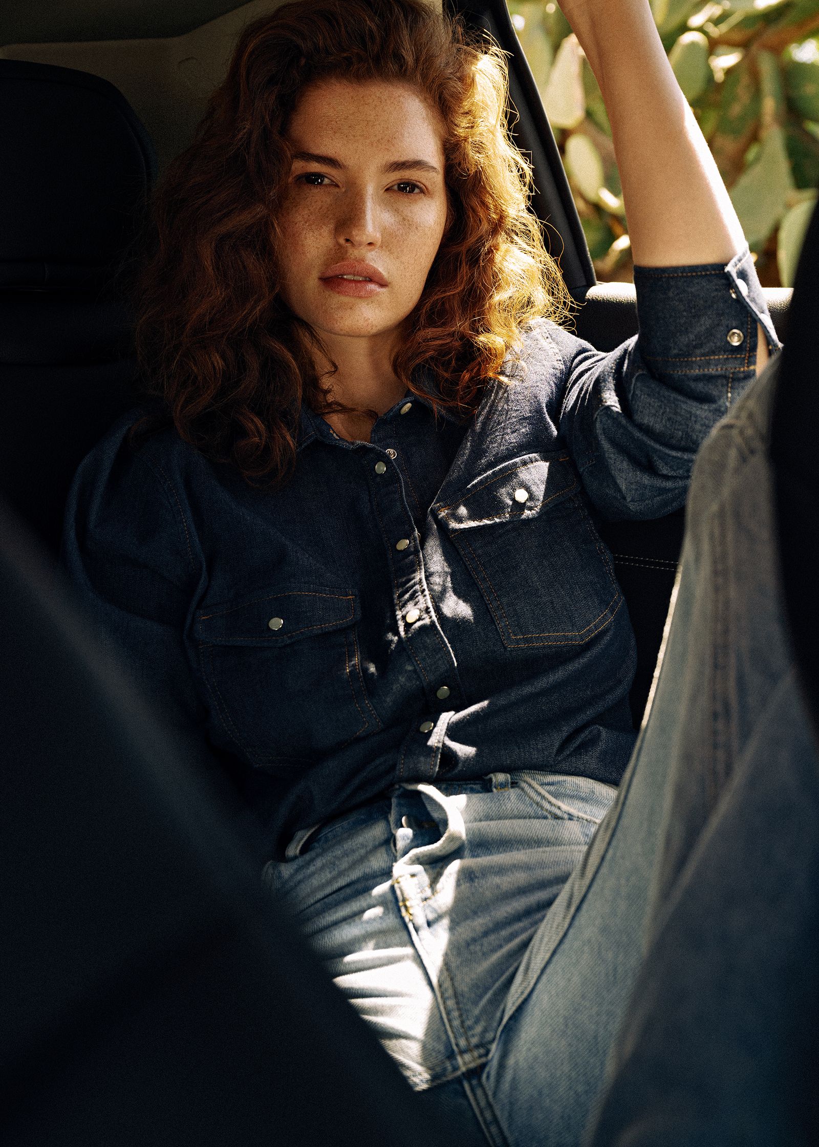 a woman sitting in the back seat of a car