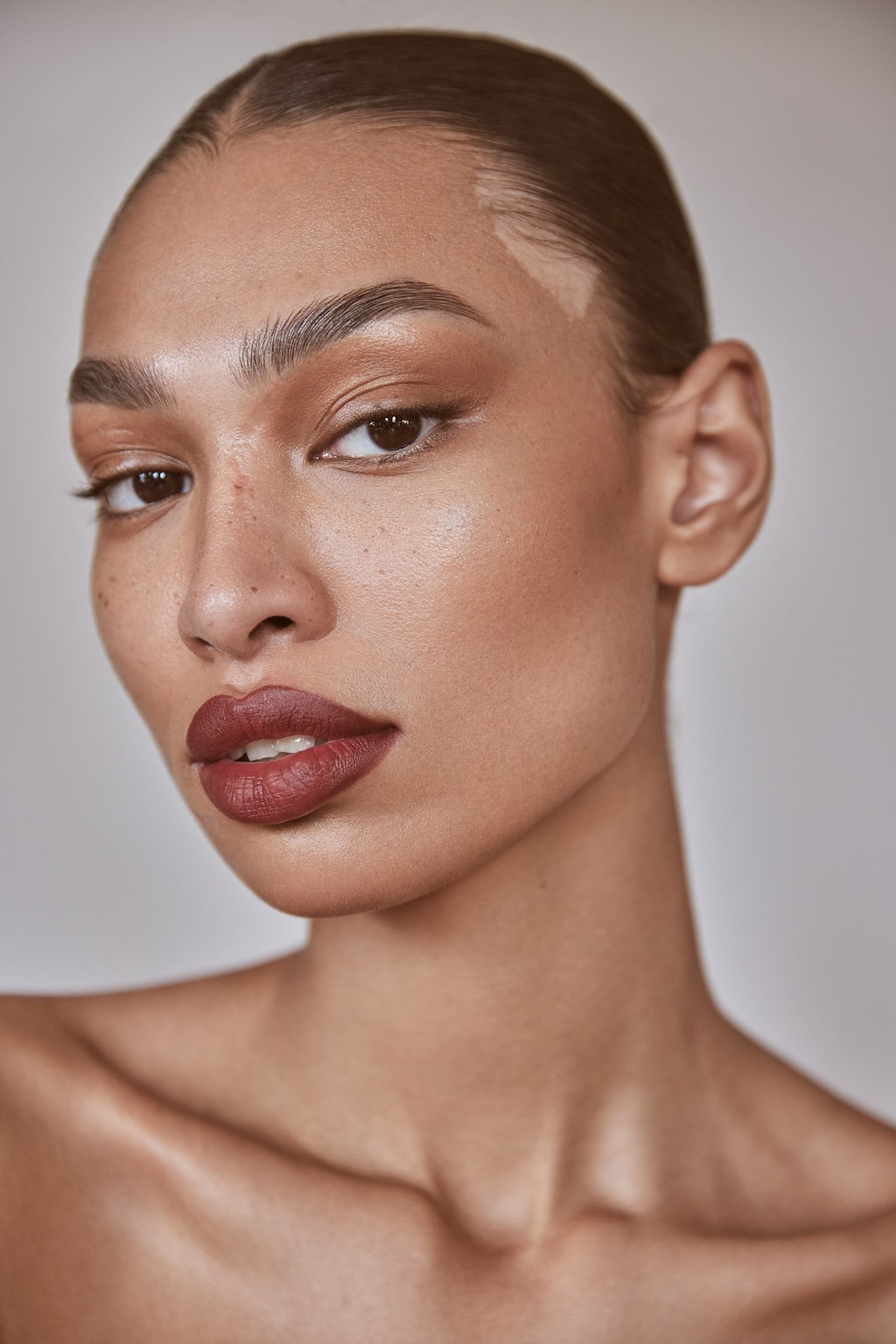 a woman with a nose piercing is posing for a photo