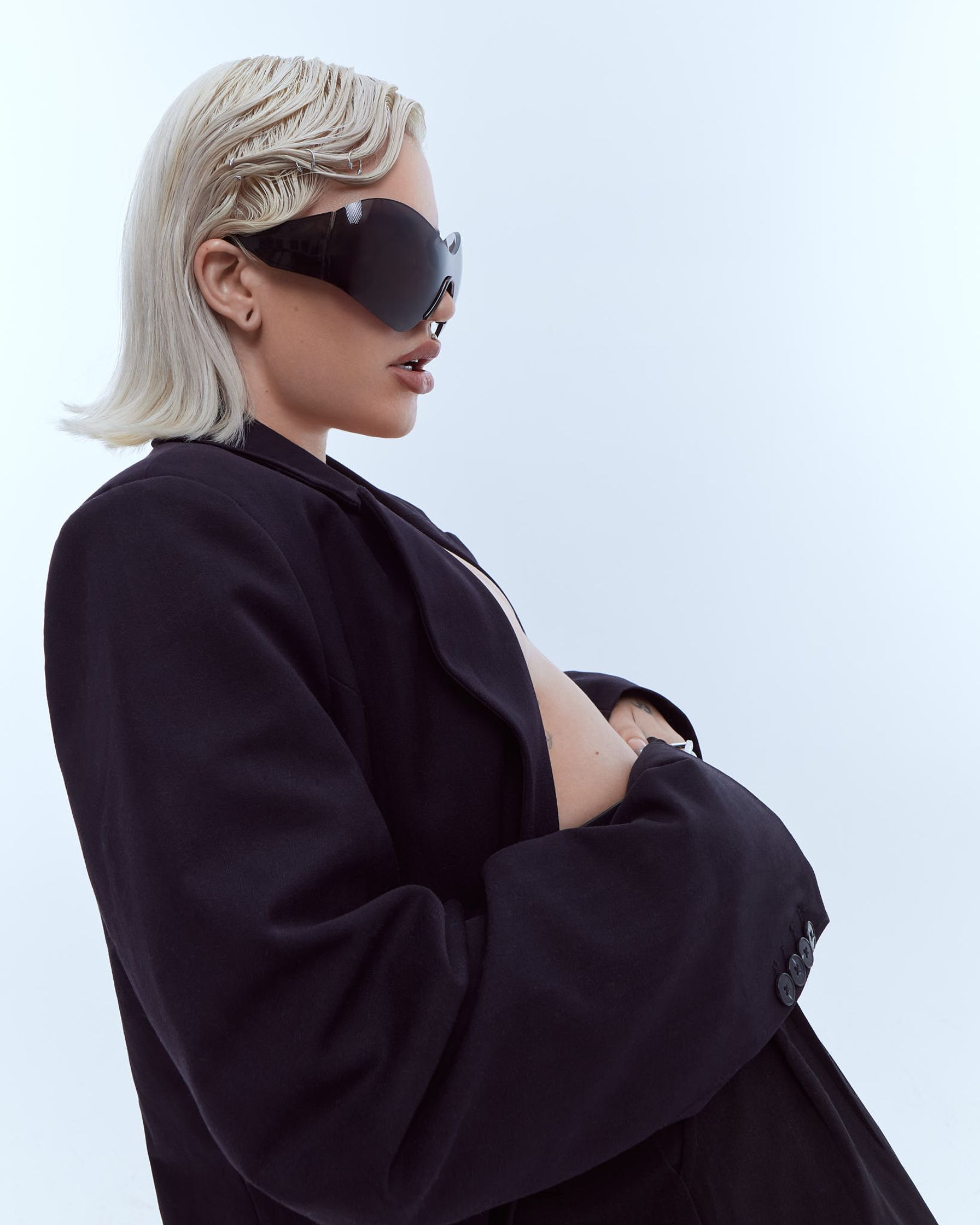 a blonde woman in a black jacket and sunglasses