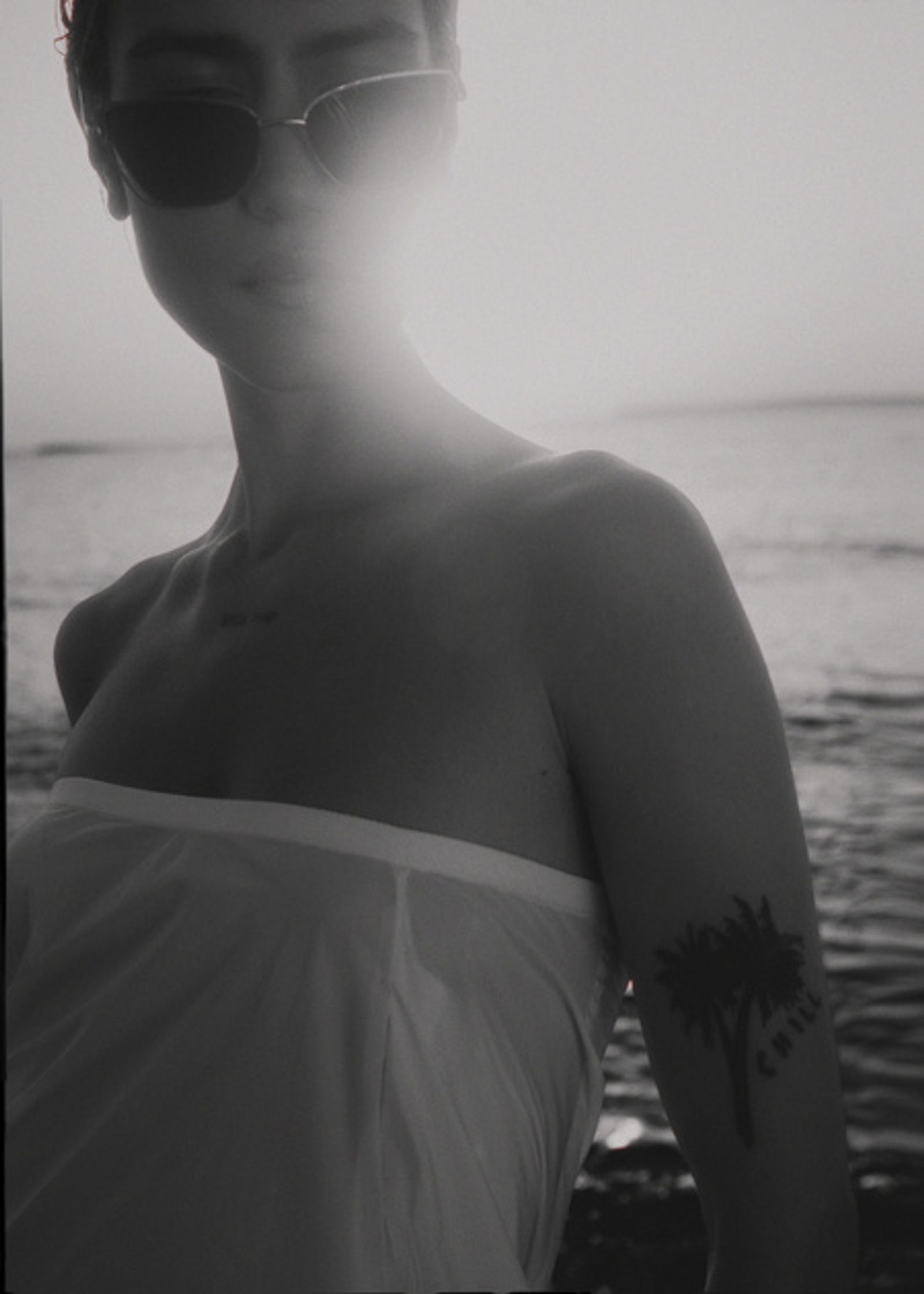 a woman wearing sunglasses on the beach