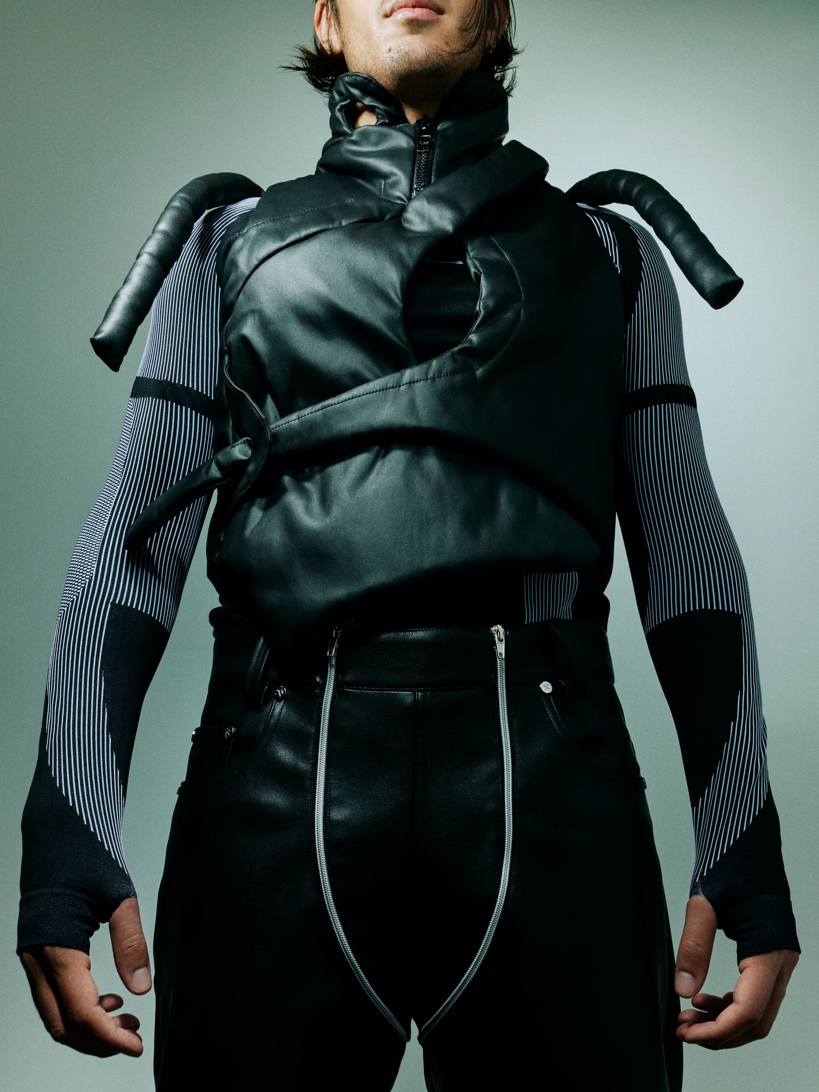 a man is wearing a leather vest