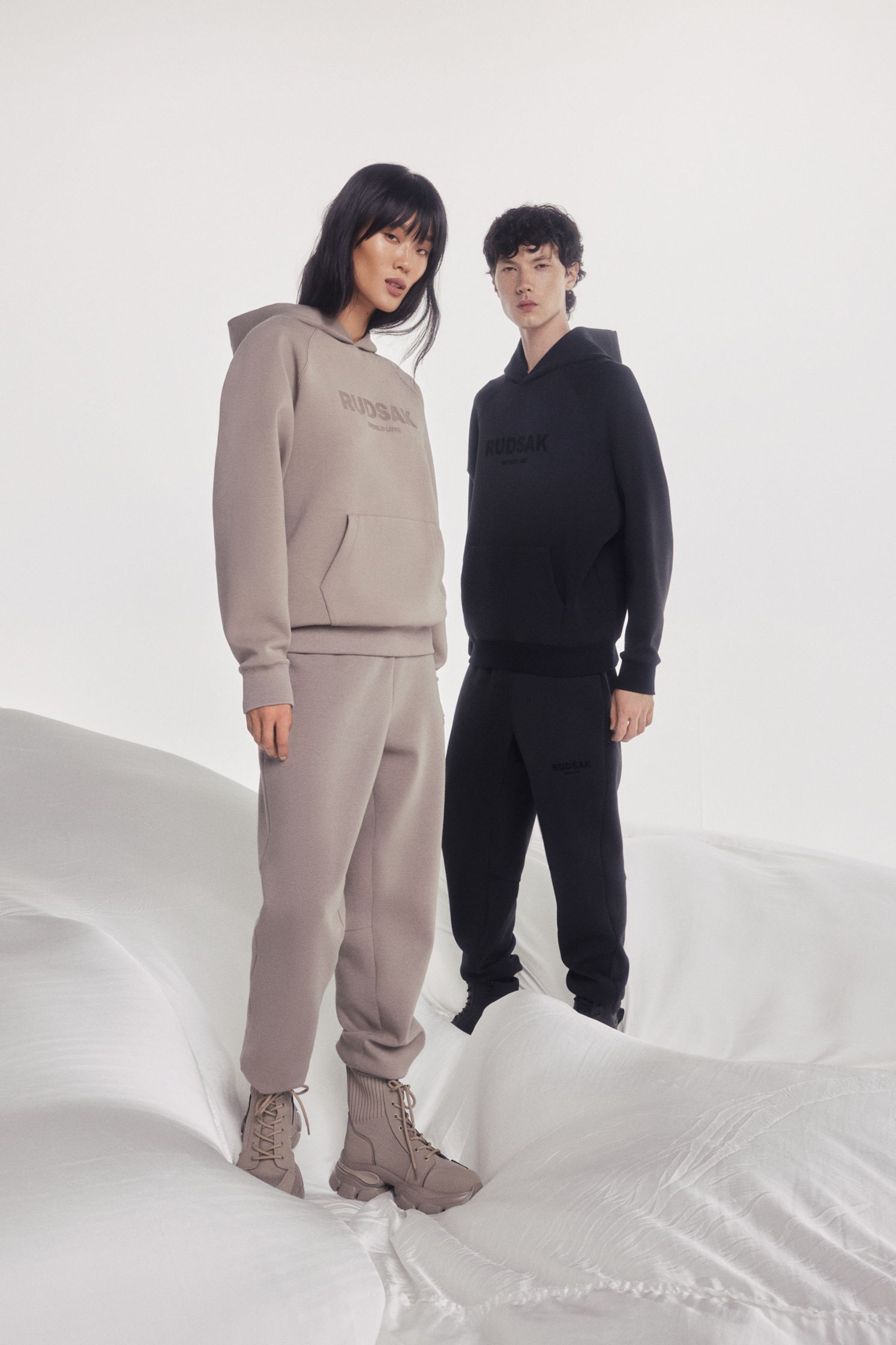 a man and a woman standing in a snowy field