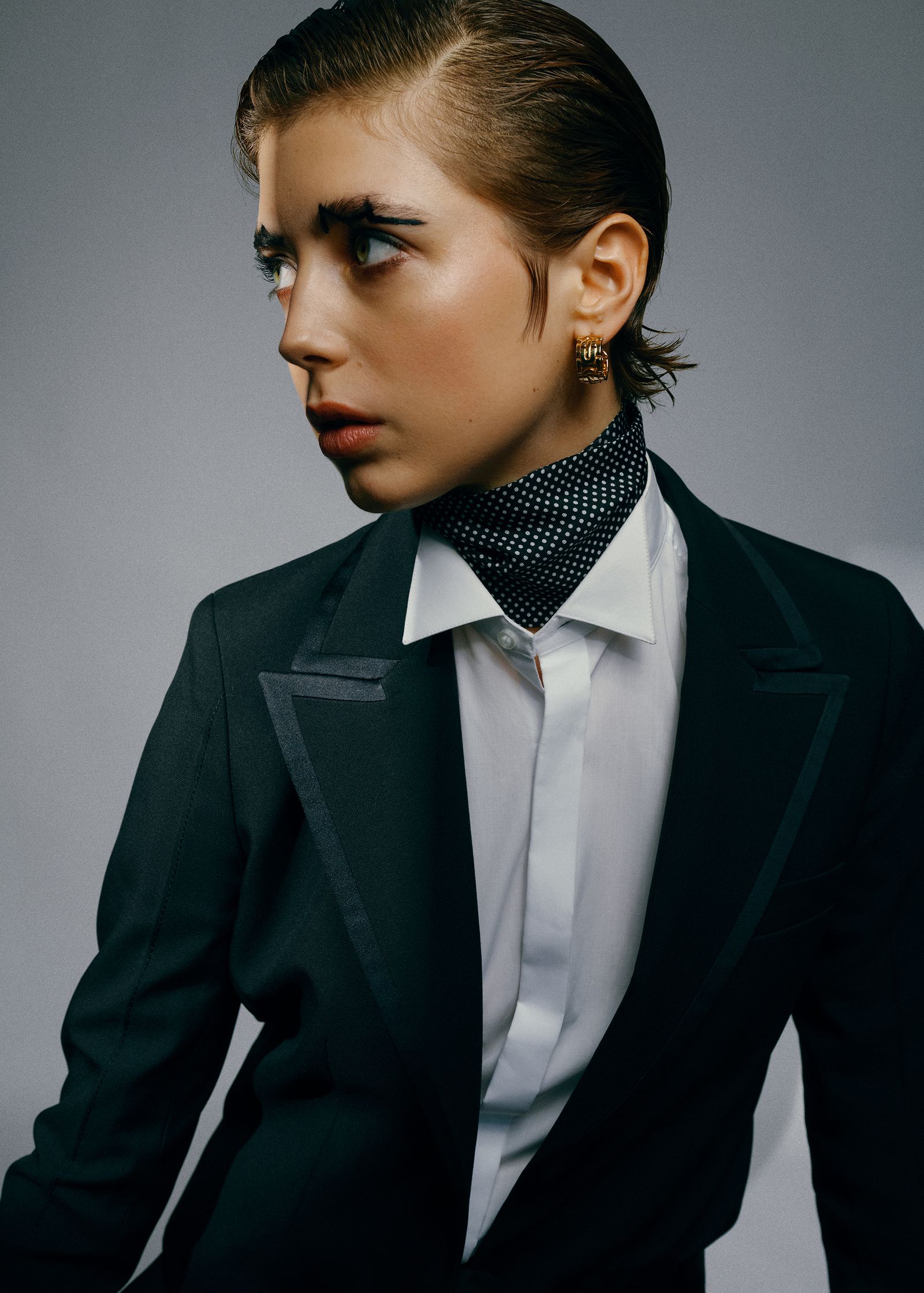 a woman in a tuxedo posing for a photo