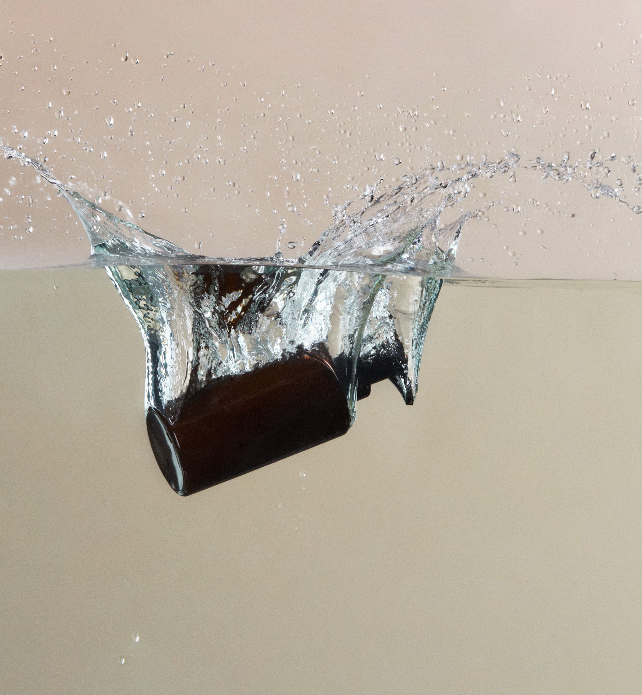 a bottle of water splashing into the water