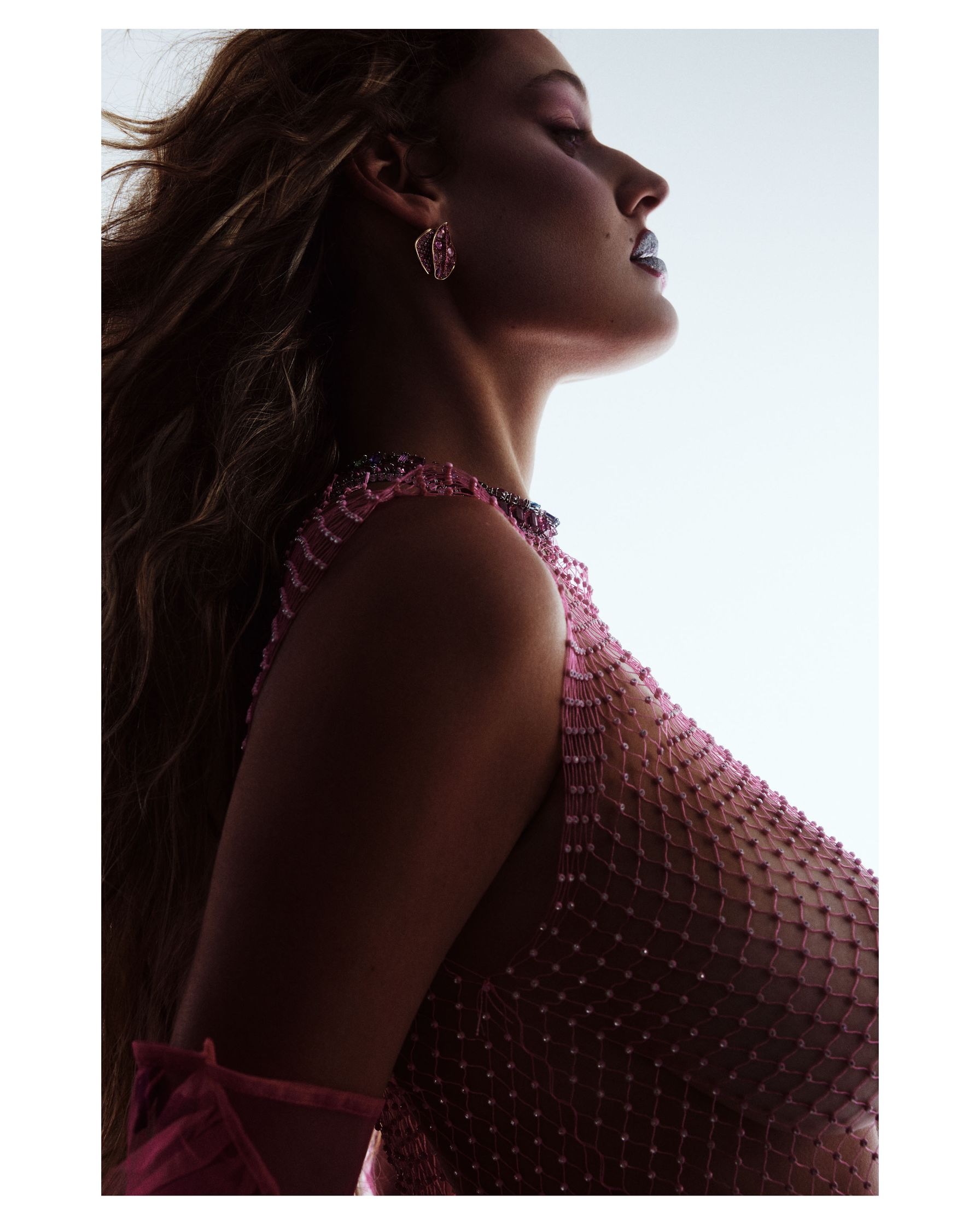 a woman with long hair in a pink dress