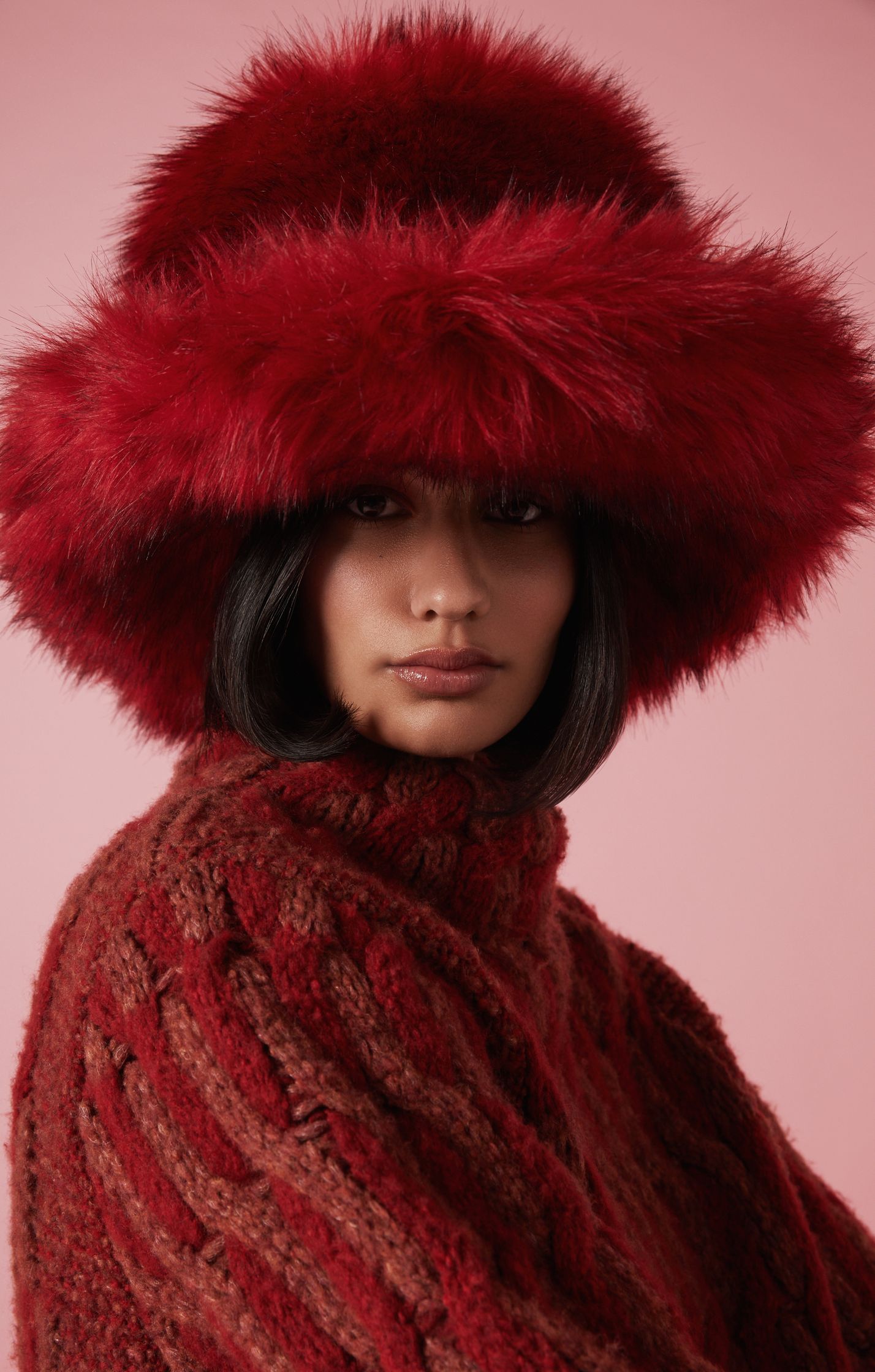 a woman wearing a red fox fur hat