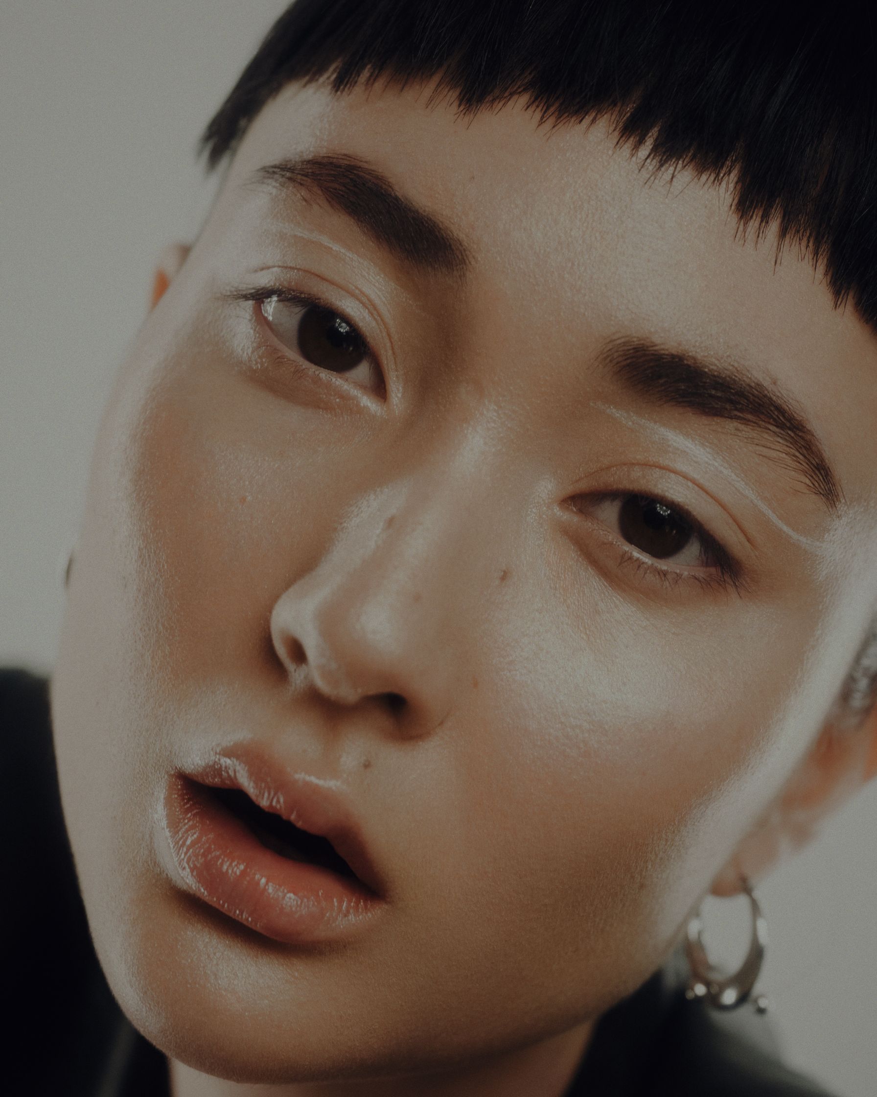 a woman with short hair and earrings