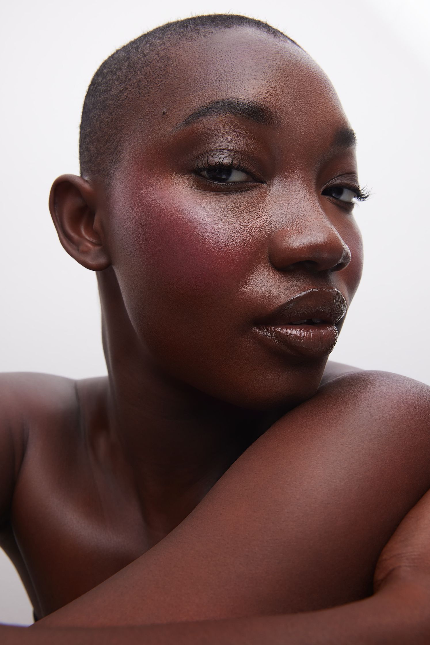 a black woman posing with makeup on her face