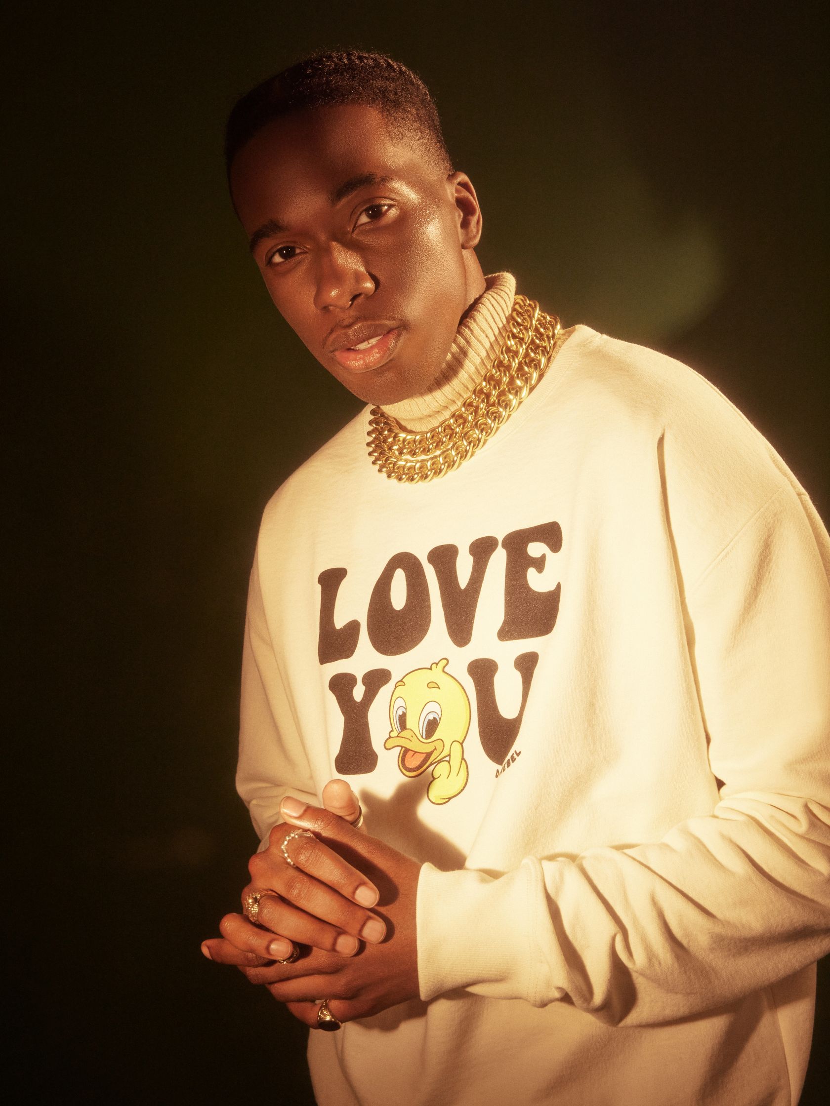 a young man wearing a white sweatshirt with the words love you on it