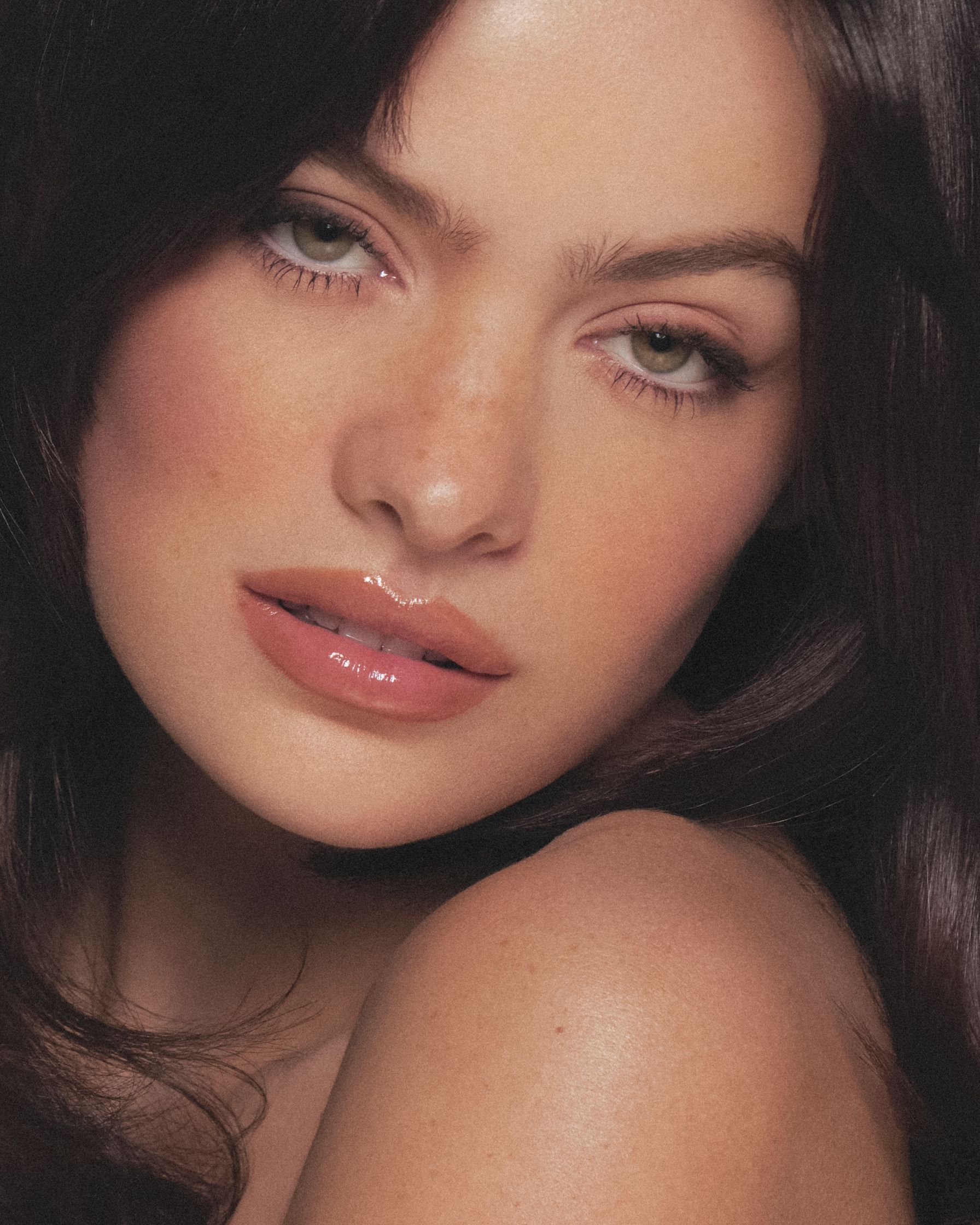 a woman with long brown hair posing for a photo