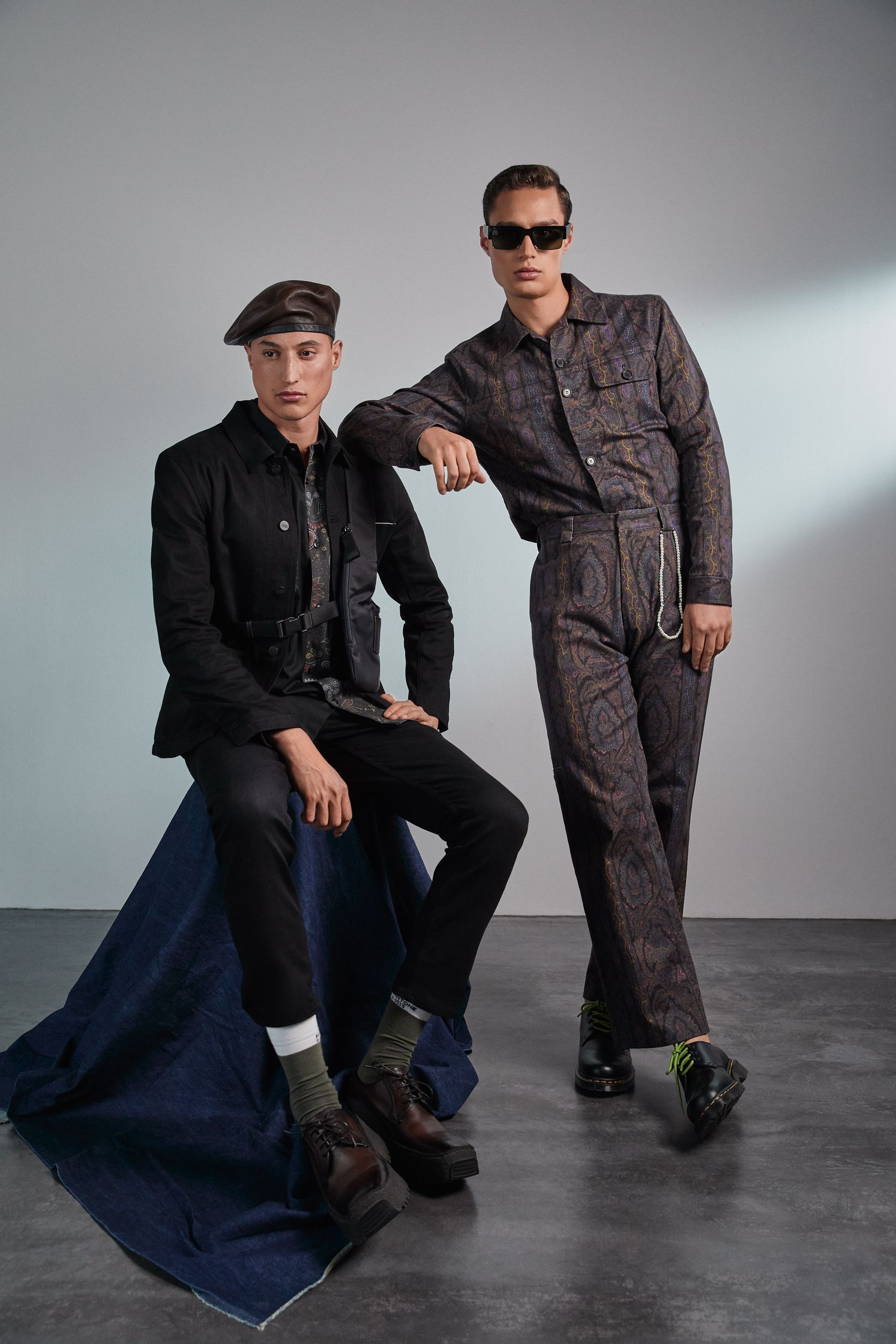 two men posing for a photo in a studio