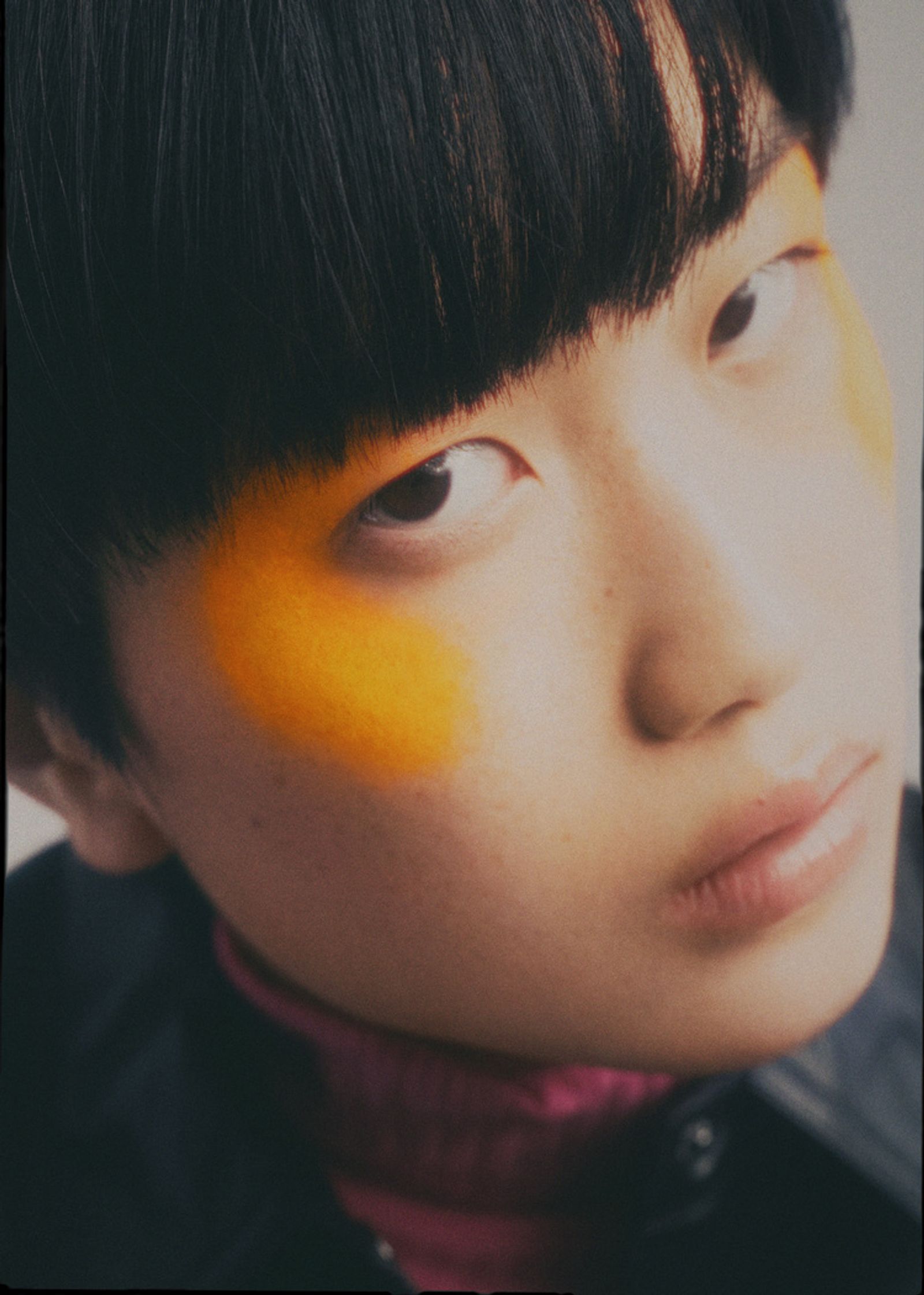 a young asian woman with orange eye makeup