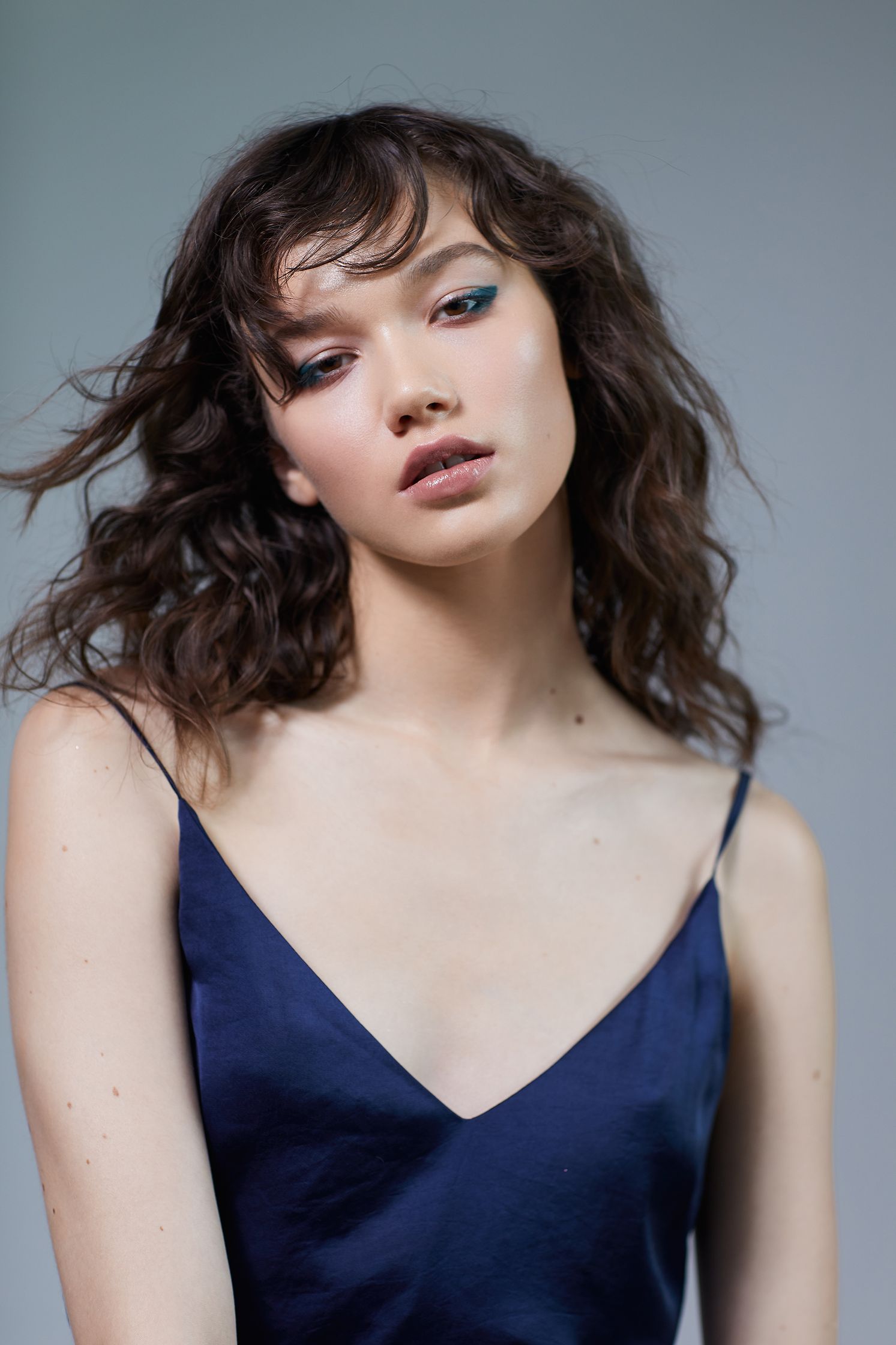 a woman in a blue dress posing for a photo