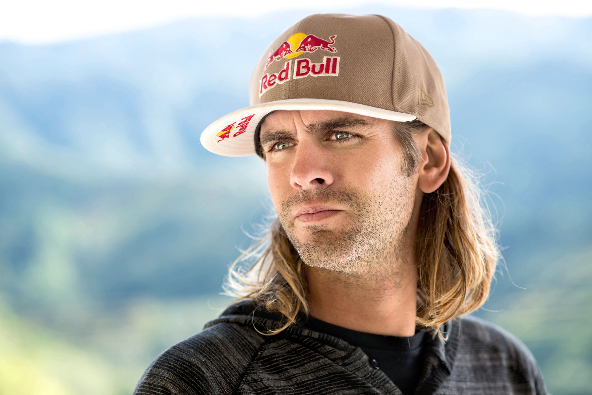Brian Grubb with long hair wearing a red bull hat