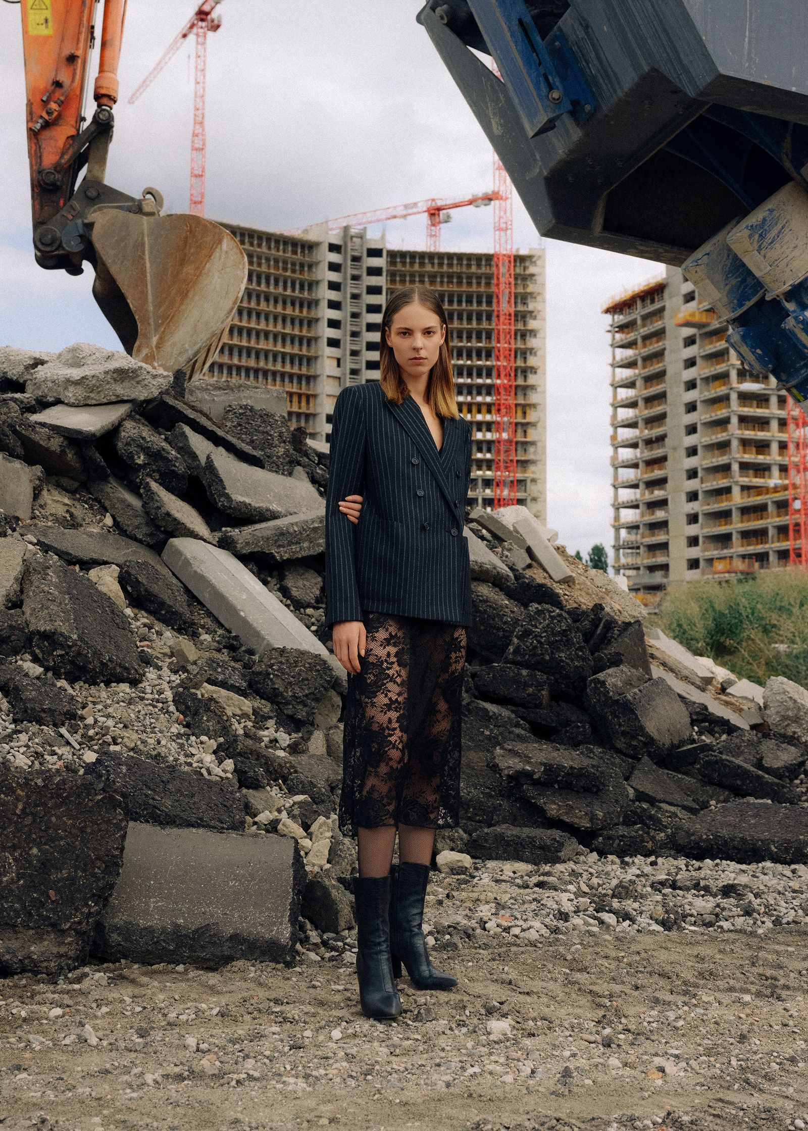 a woman standing in front of a construction site