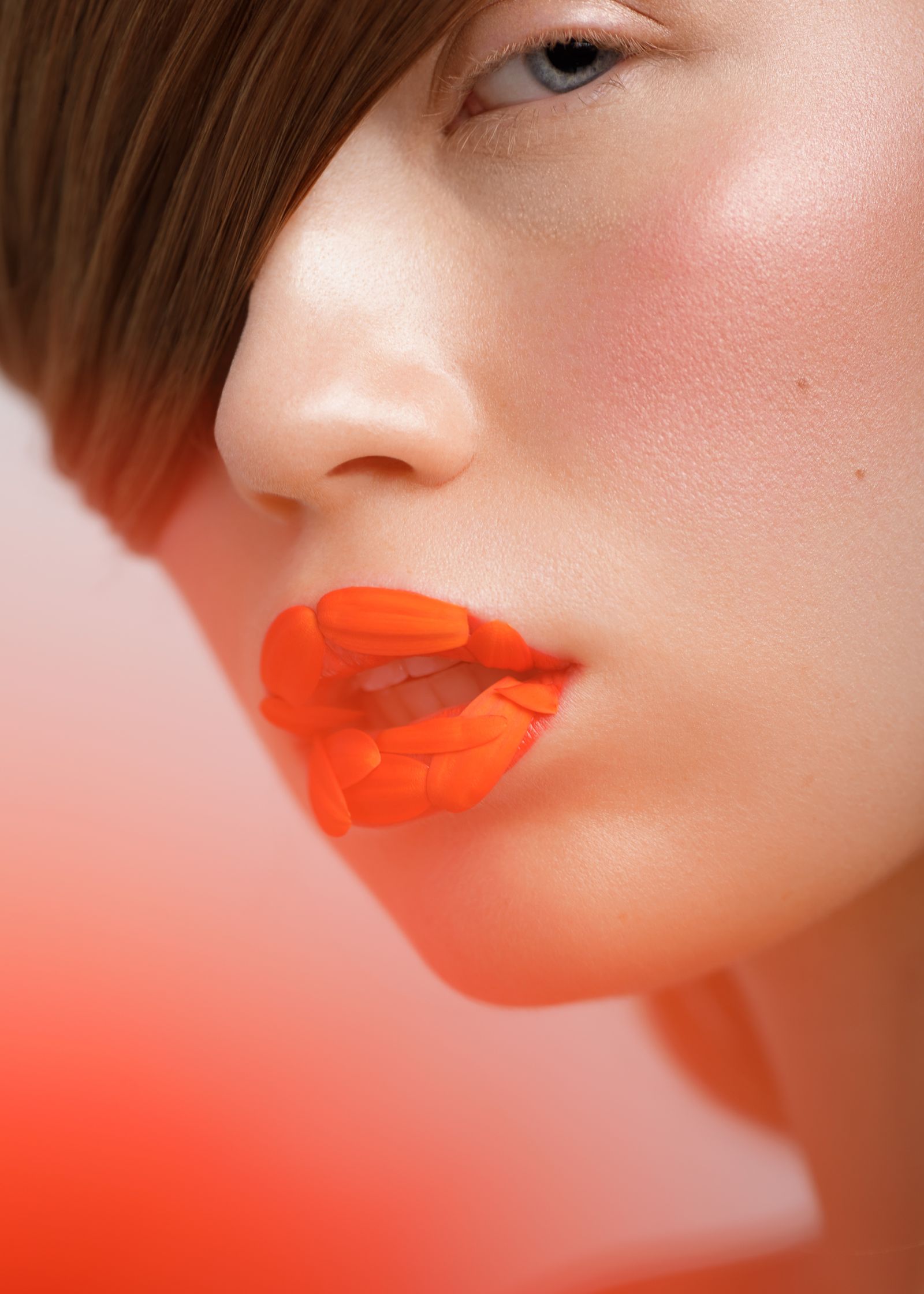 a close up of a woman with orange lips