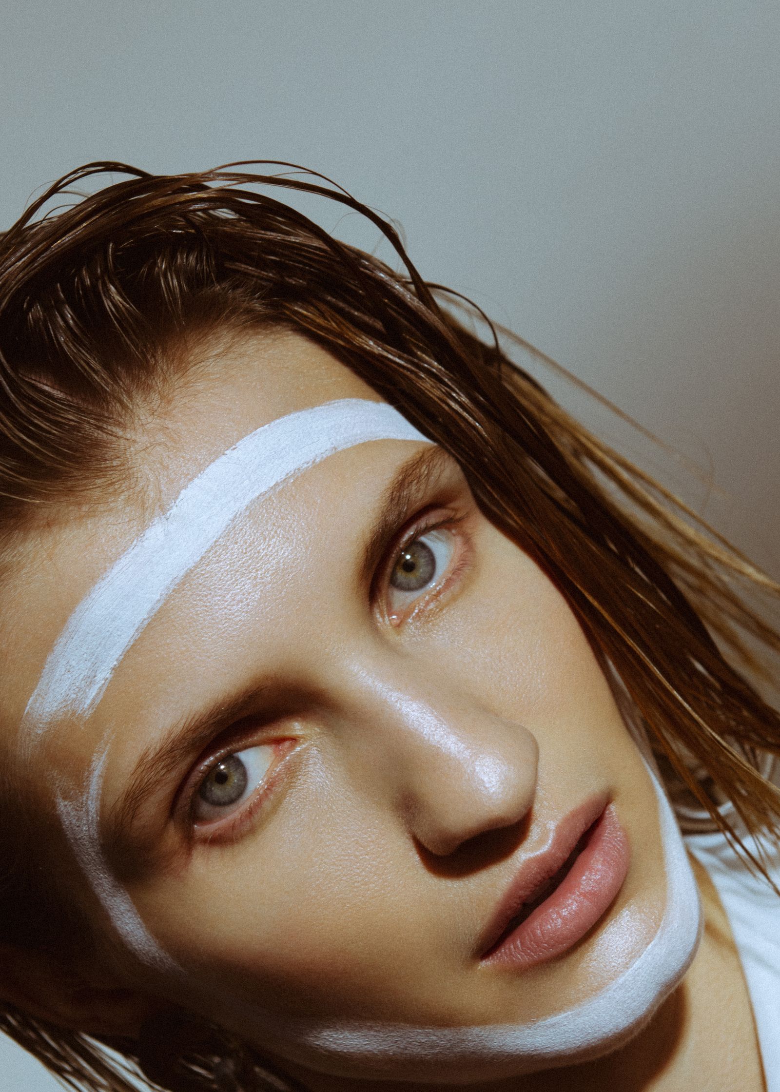 a woman with white makeup on her face