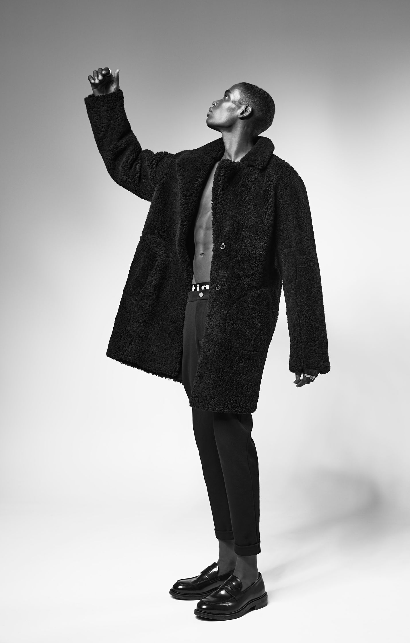 a black and white photo of a man in a black coat