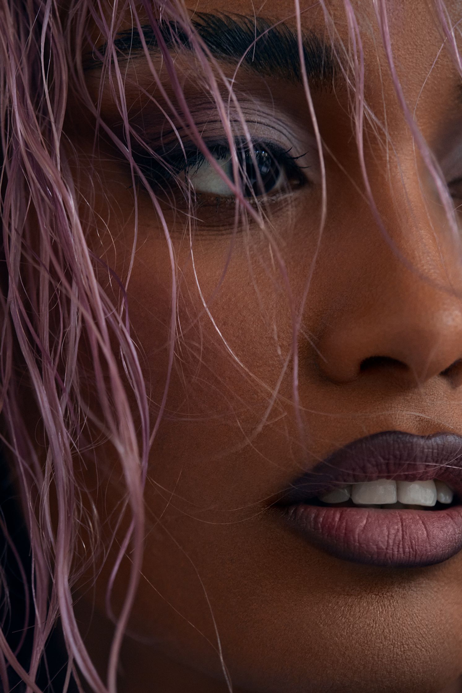 a close up of a woman with purple hair