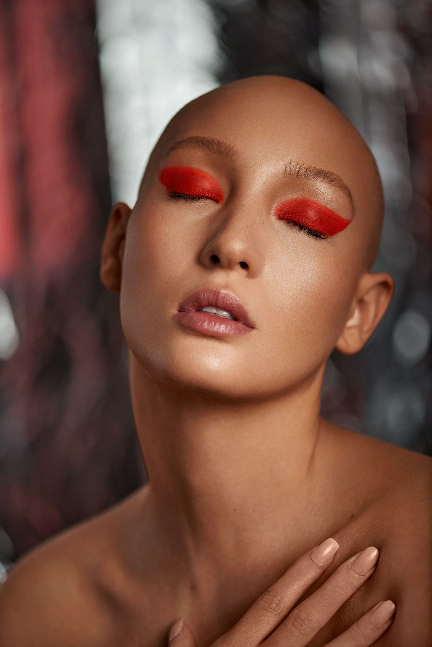 a woman with red eyes and a bald head