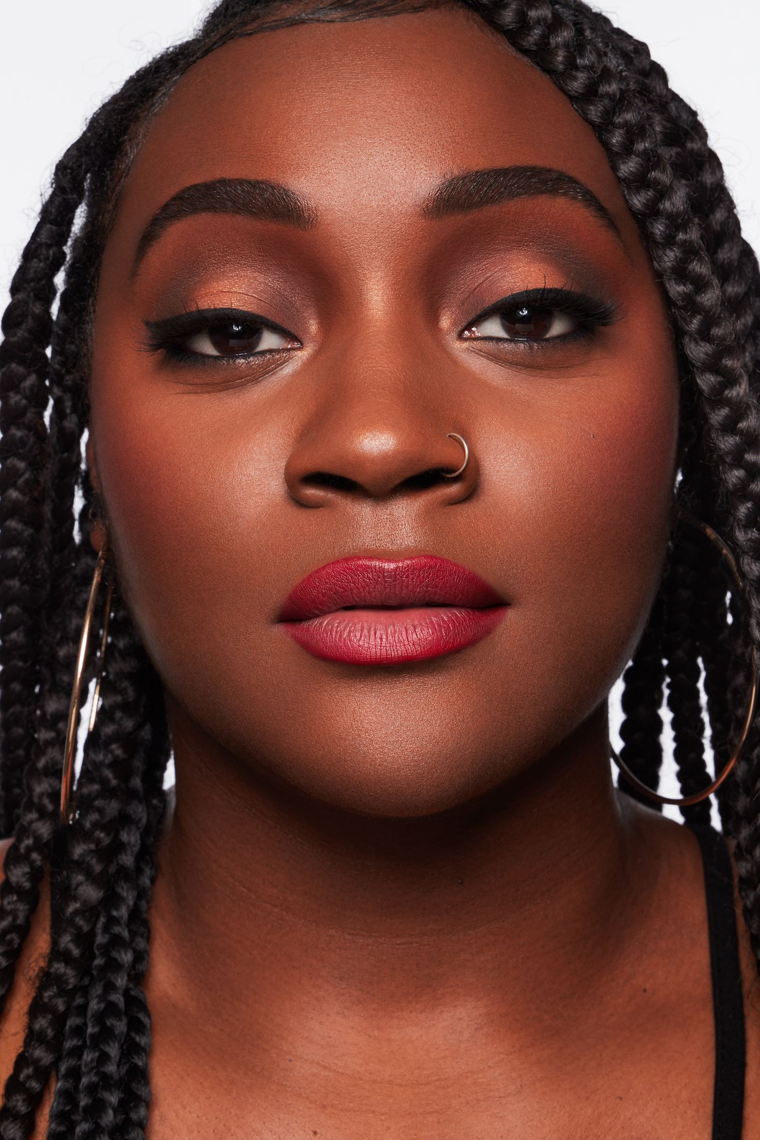 a black woman with braided hair and red lips