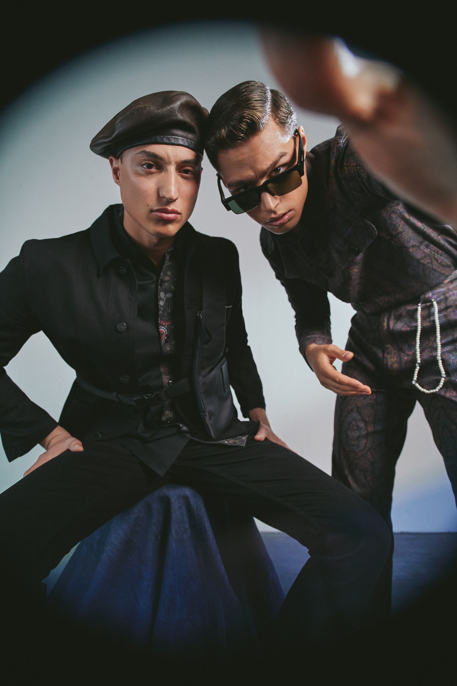 two men posing for a picture in a mirror