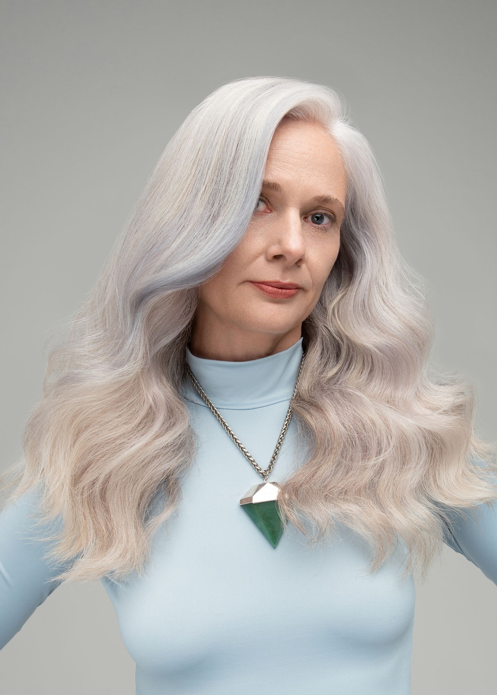 a woman with long white hair posing for a photo