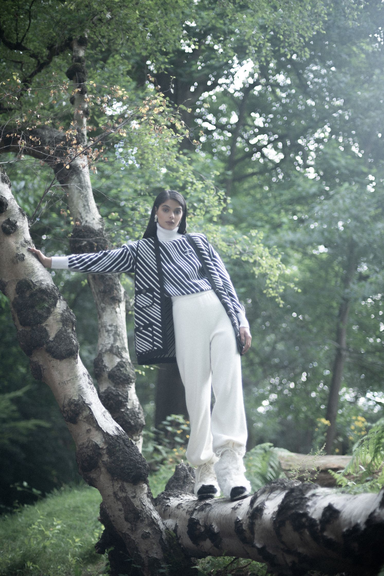 a person standing on a tree trunk