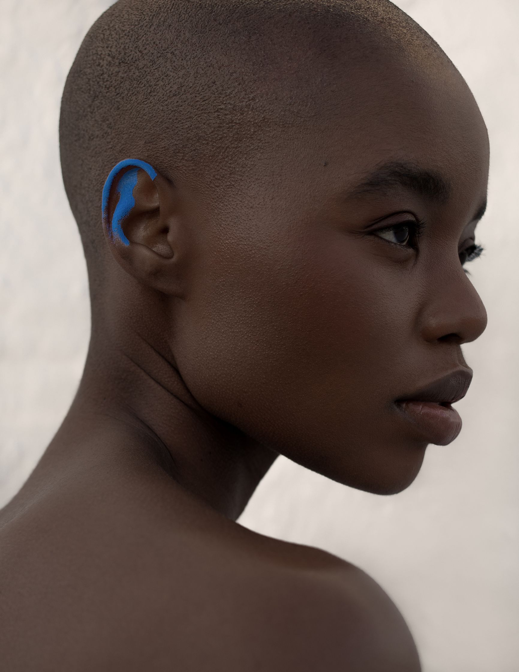 a black woman with a blue ear piercing