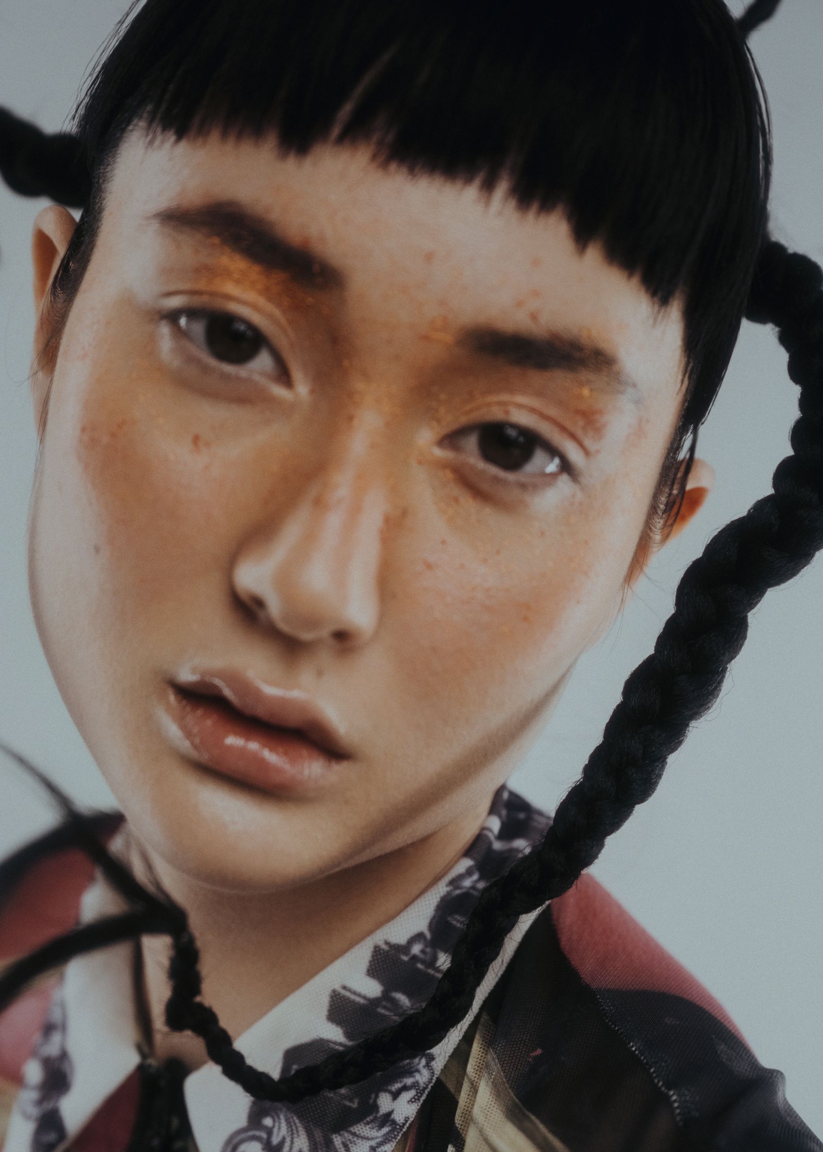 a woman with braided hair is posing for a photo