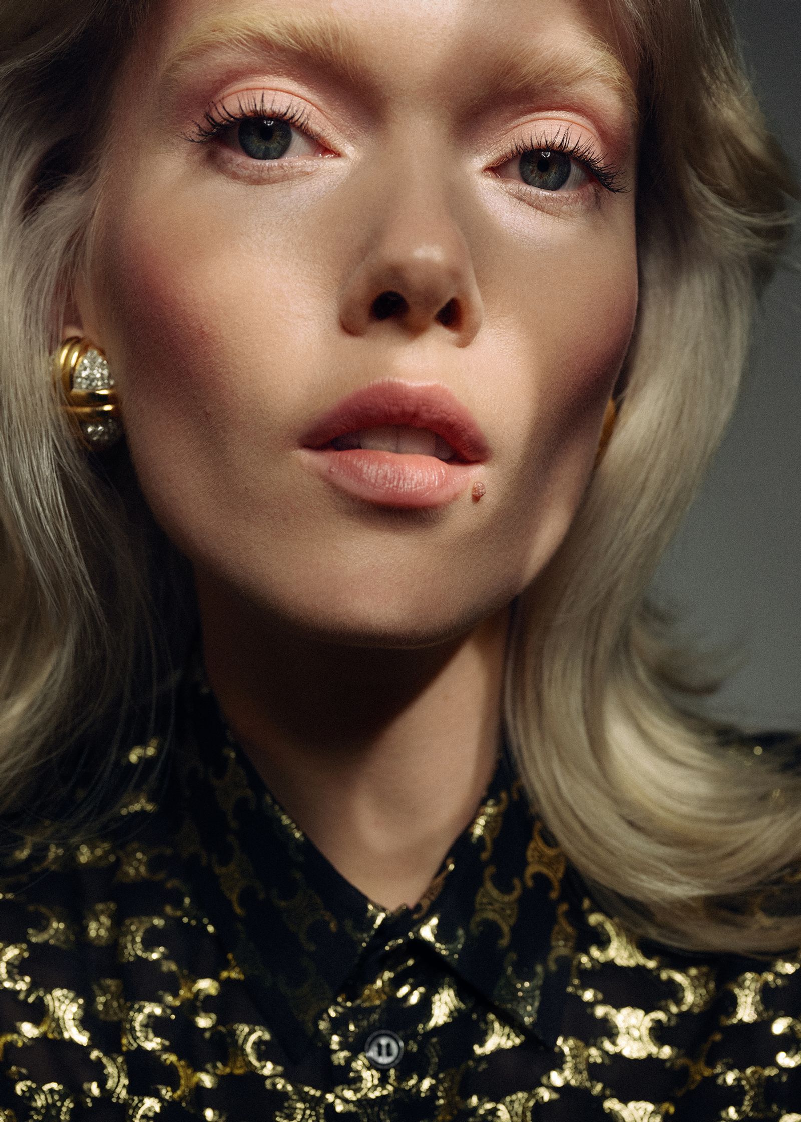 a blonde woman in a leopard print shirt posing for a magazine