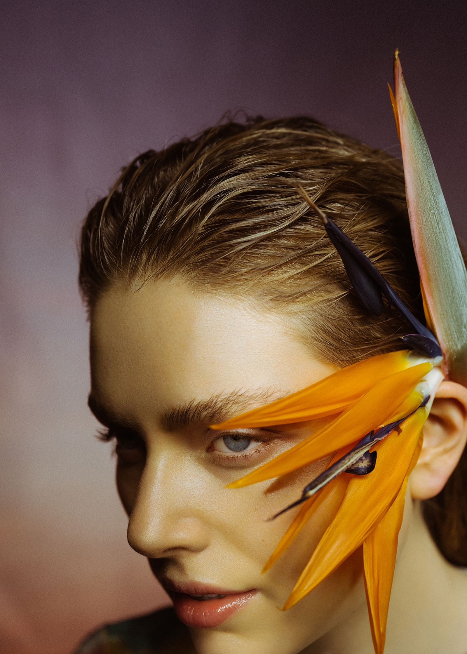 a woman with bird feathers on her head