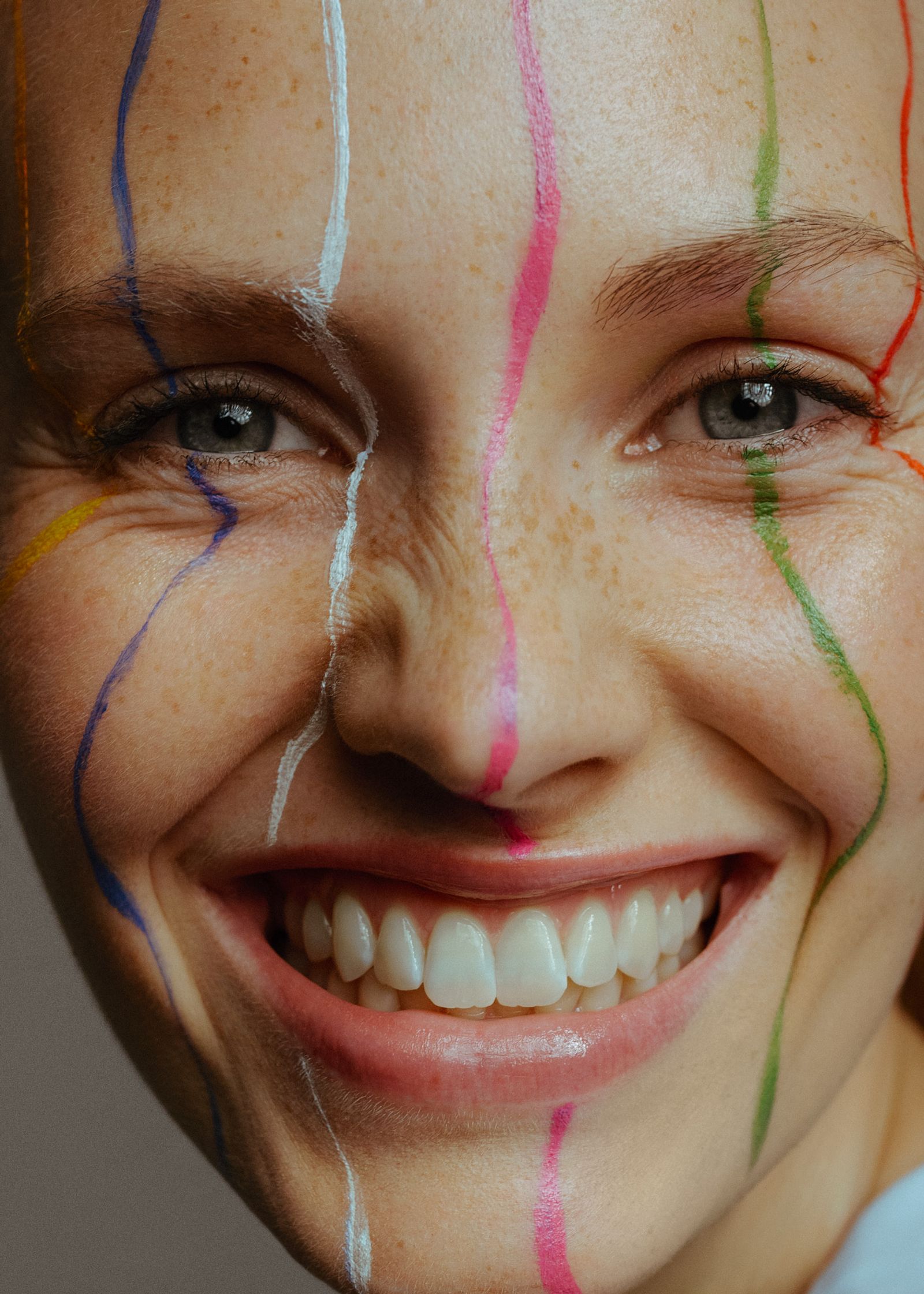 a woman with colorful paint on her face