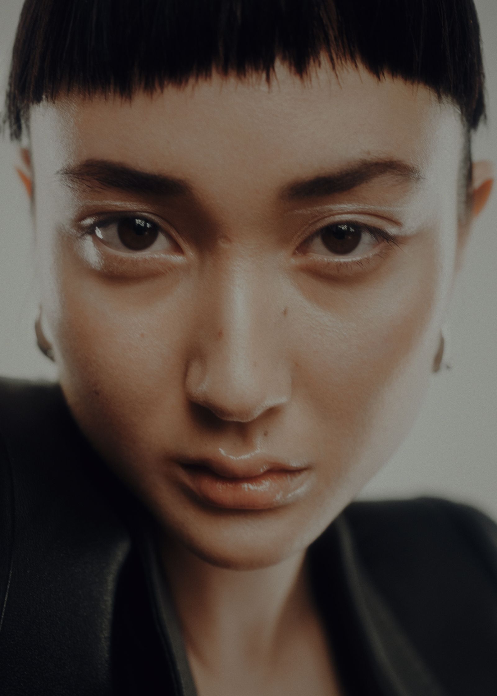 a woman with short hair is looking at the camera