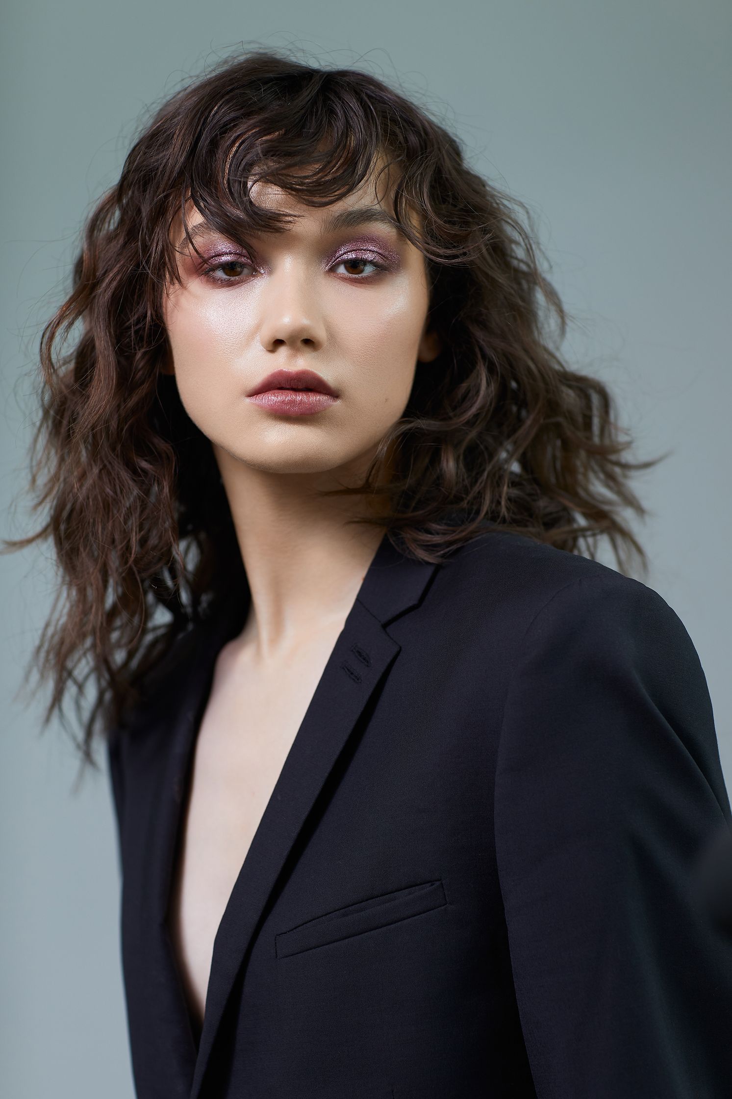 a woman in a black suit posing for a photo