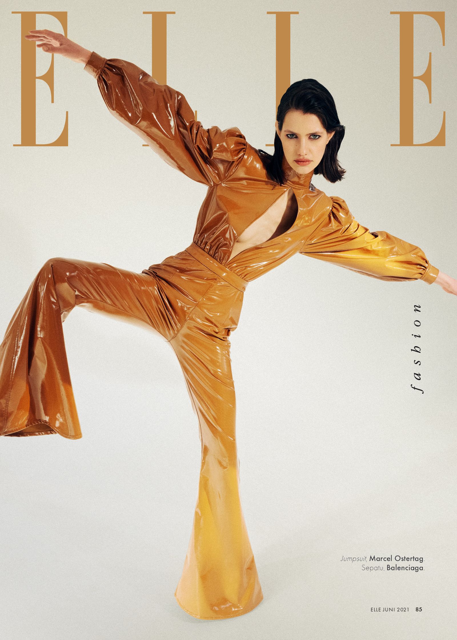 the cover of elle magazine featuring a woman in an orange suit