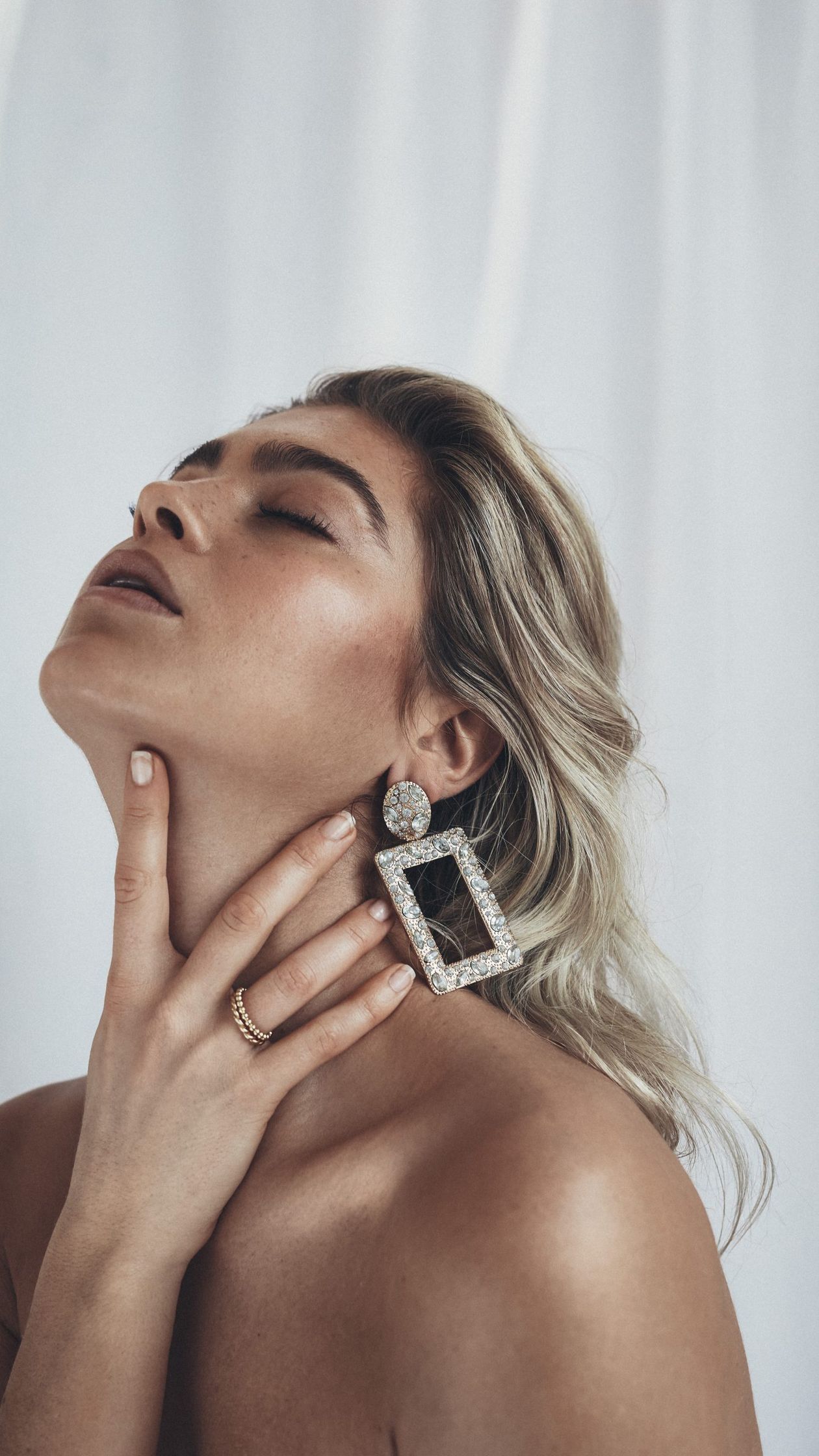 a woman posing with her hands on her face