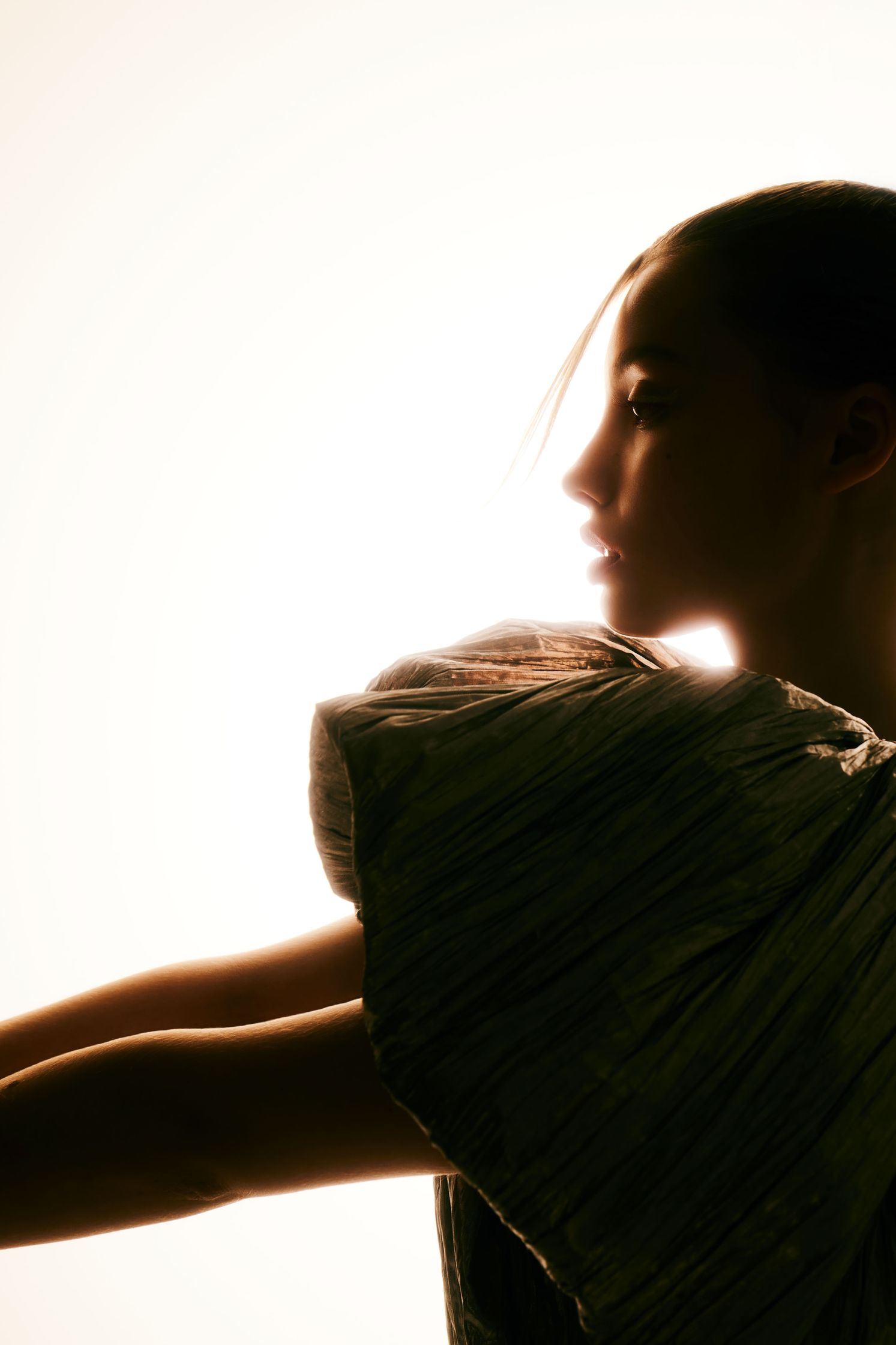a silhouette of a woman with her arms outstretched